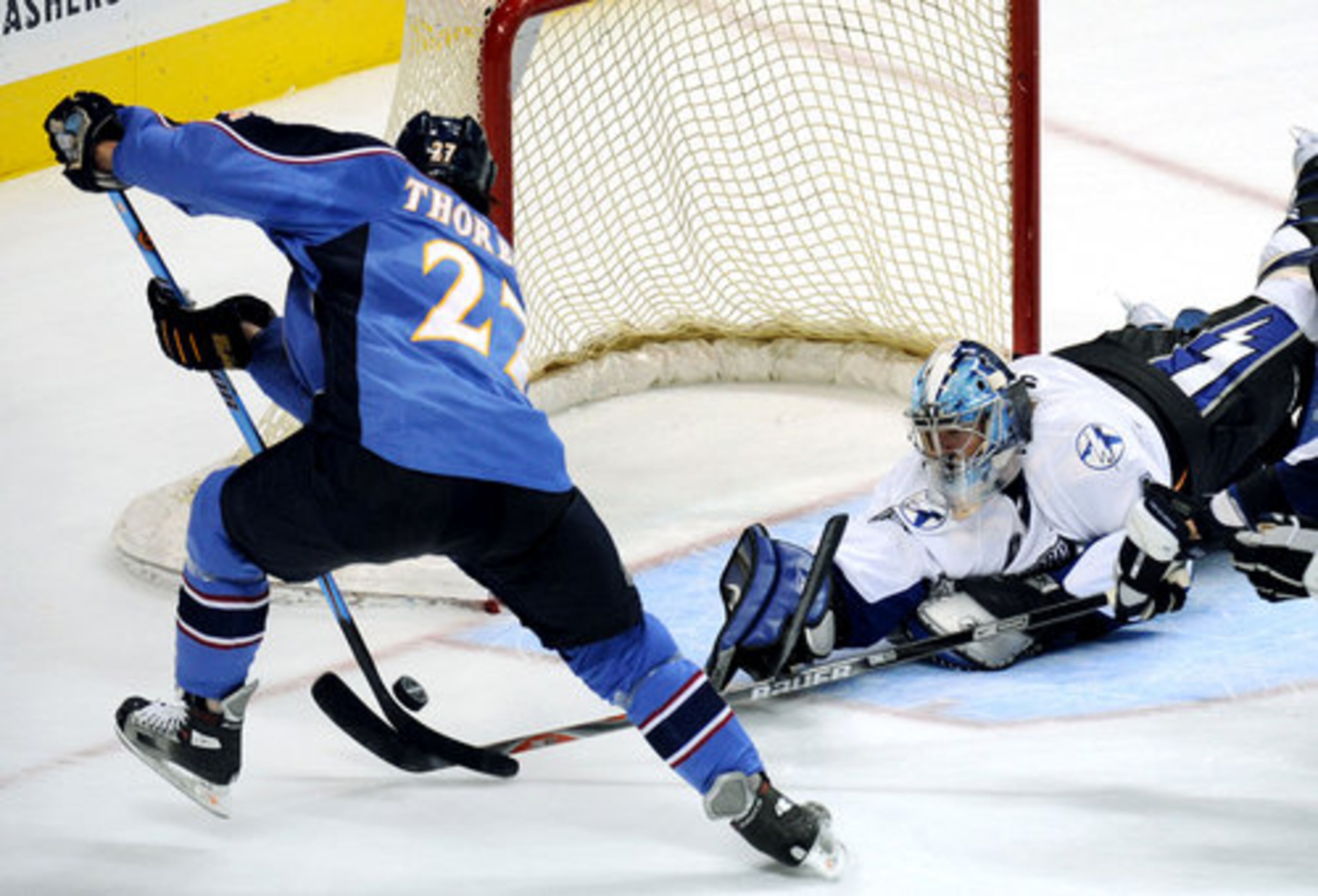 Thrasher's Chris Thorburn tries to get a puck in on Tampa goalie Mike Smith in the second period, but he did not.