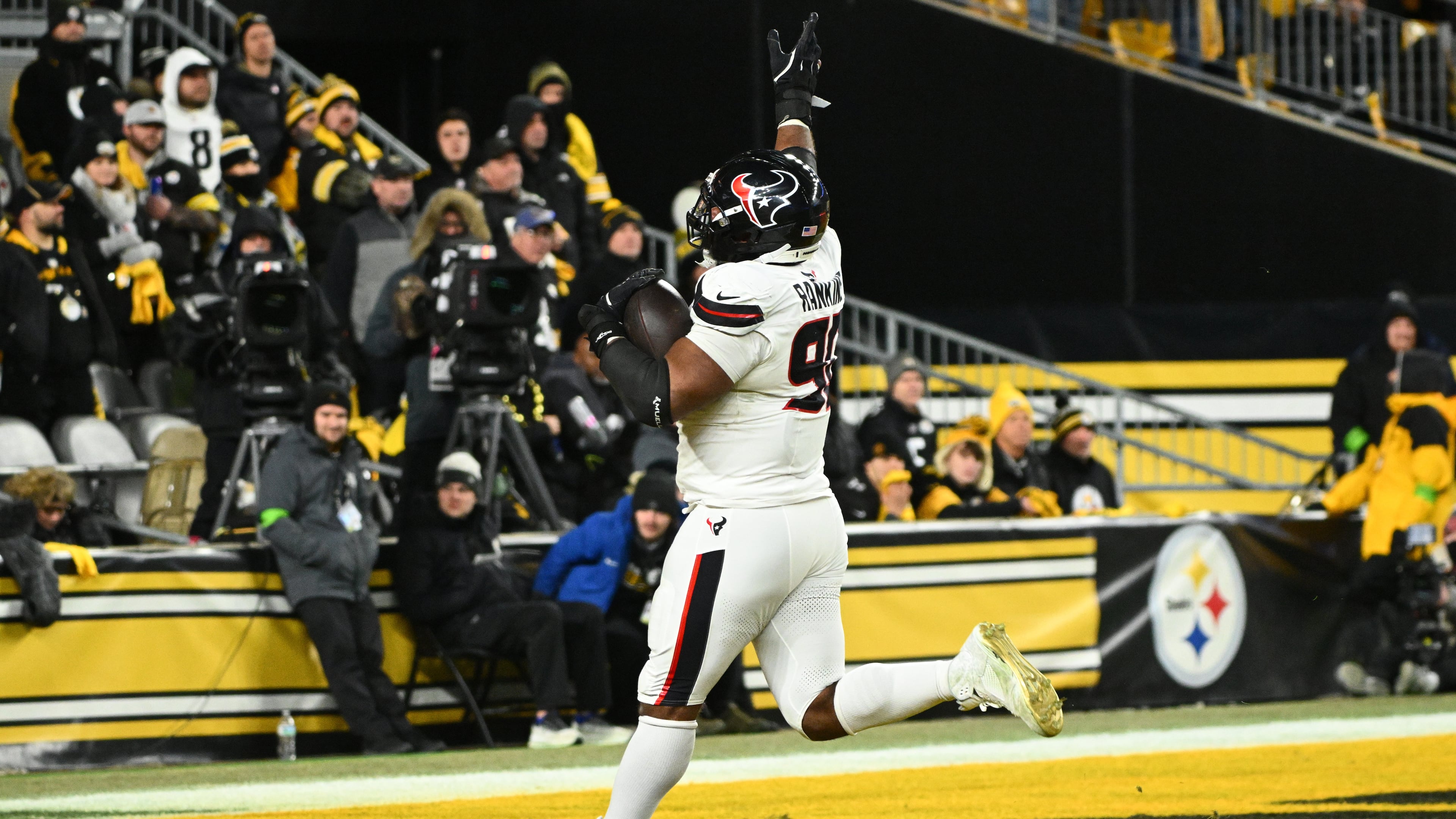 Houston Texans defensive tackle Sheldon Rankins runs to the end zone for a touchdown after recovering a fumble during the second half of an NFL wild-card playoff football game against the Pittsburgh Steelers, Monday, Jan. 12, 2026, in Pittsburgh. (AP Photo/Justin Berl)
