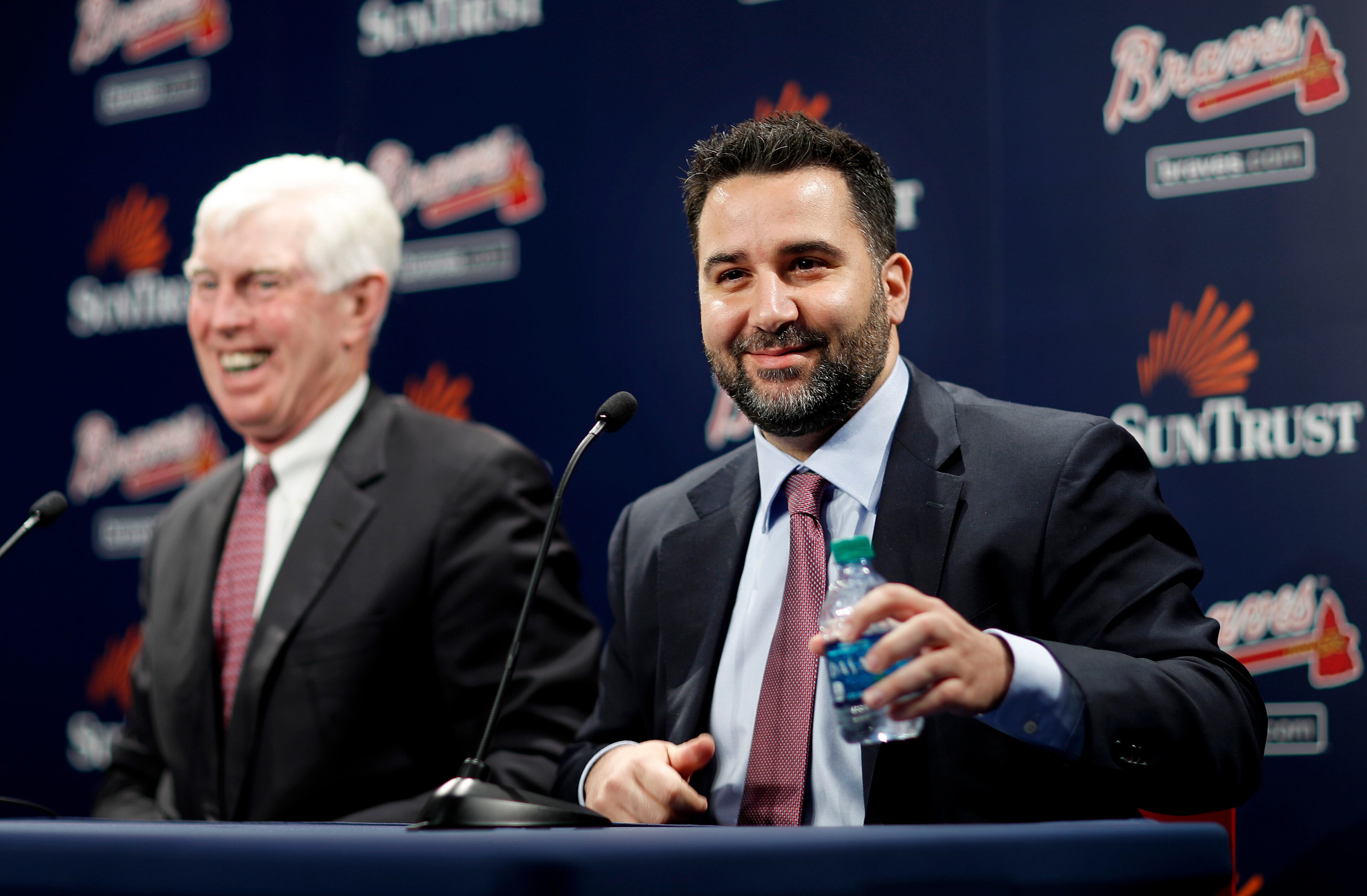 Alex Anthopoulos, right, speaks at a news conference introducing him as the new general manager of the Atlanta Braves baseball team by Terry McGuirk, chairman and CEO, in Atlanta, Monday, Nov. 13, 2017. (AP Photo/David Goldman)