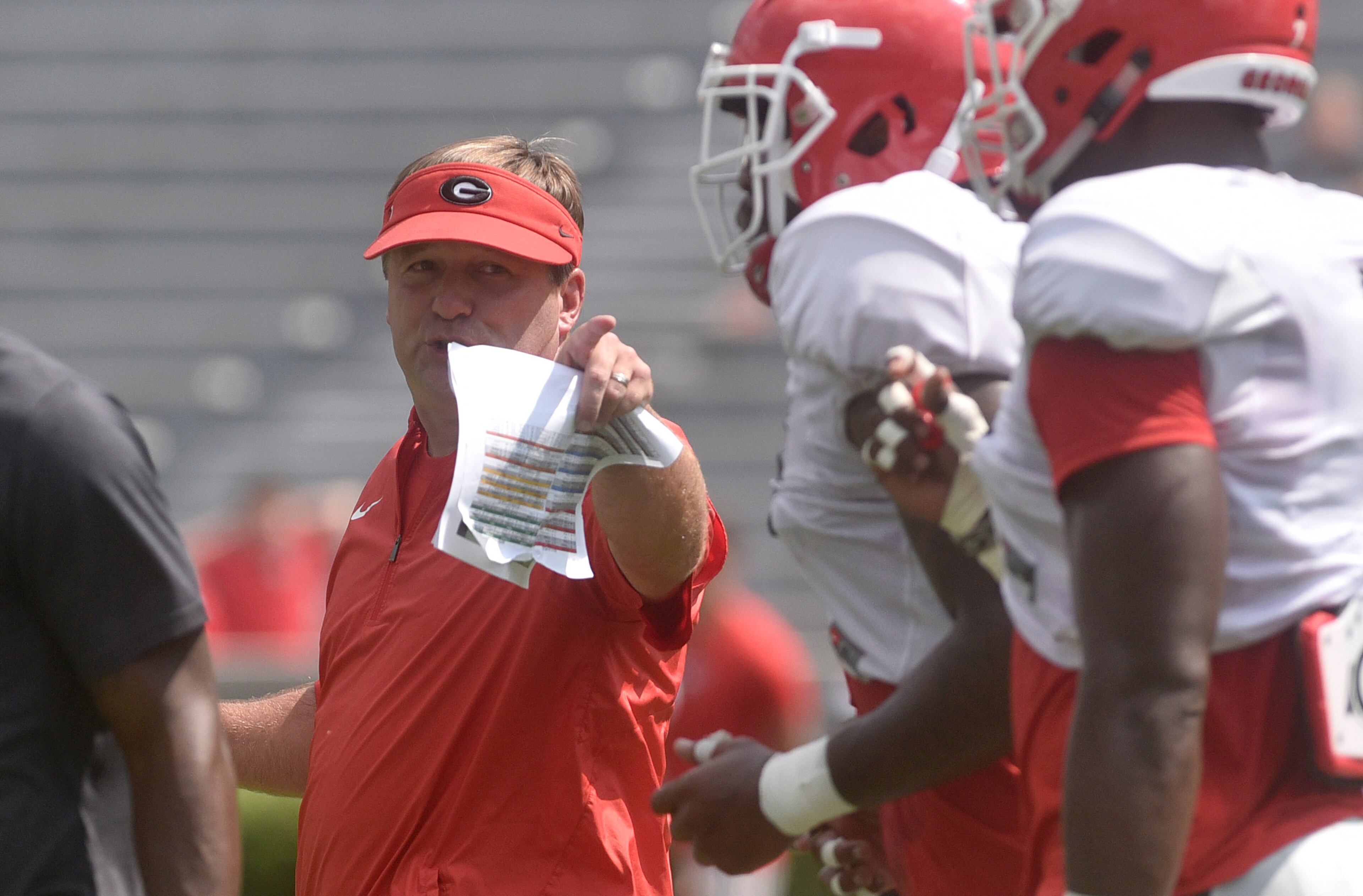 Georgia Kirby Smart talks to a group of Bulldogs during the annual UGA Fan Day at Sanford Stadium on Saturday, Aug 5, 2017 in Athens, Ga.
(RICHARD HAMM)