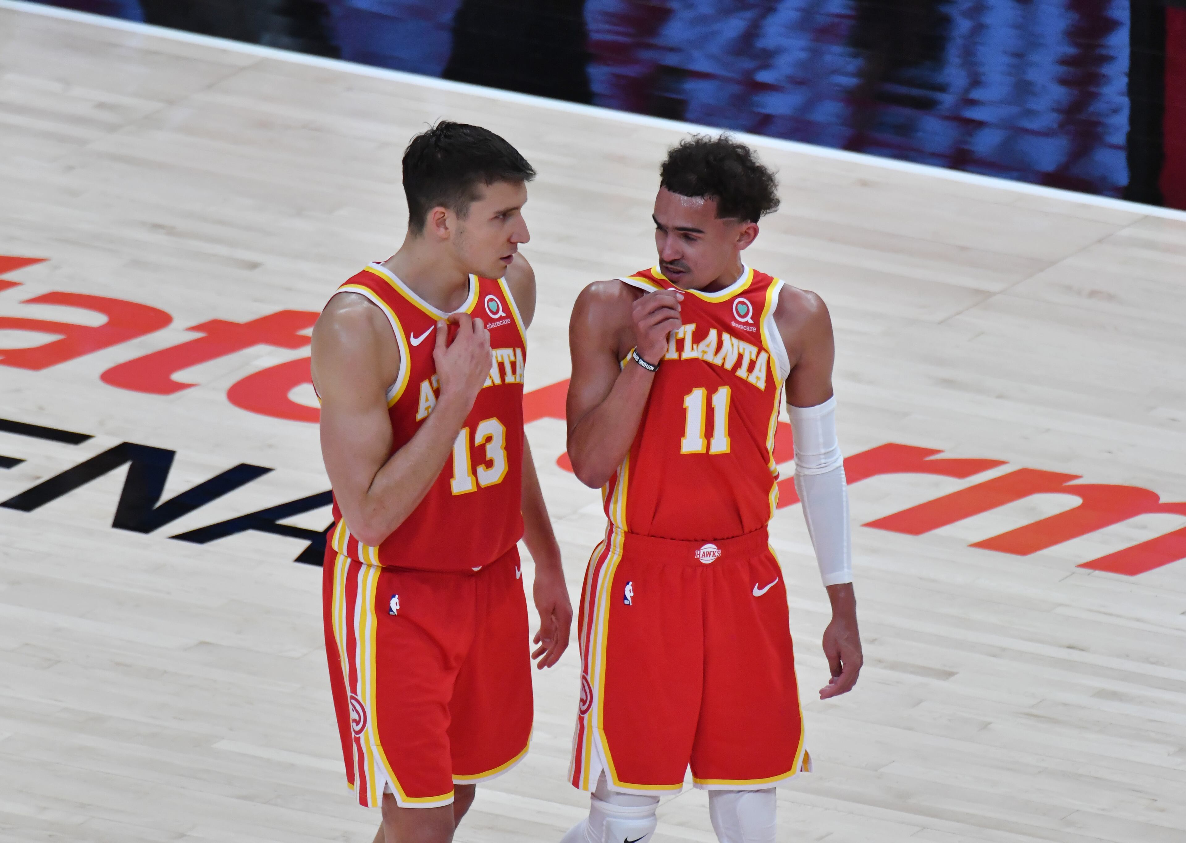 Hawks guard Bogdan Bogdanovic (13) and teammate Trae Young (11) talk during a win over the Bulls at State Farm Arena on Saturday, May 1, 2021. (Hyosub Shin / Hyosub.Shin@ajc.com)