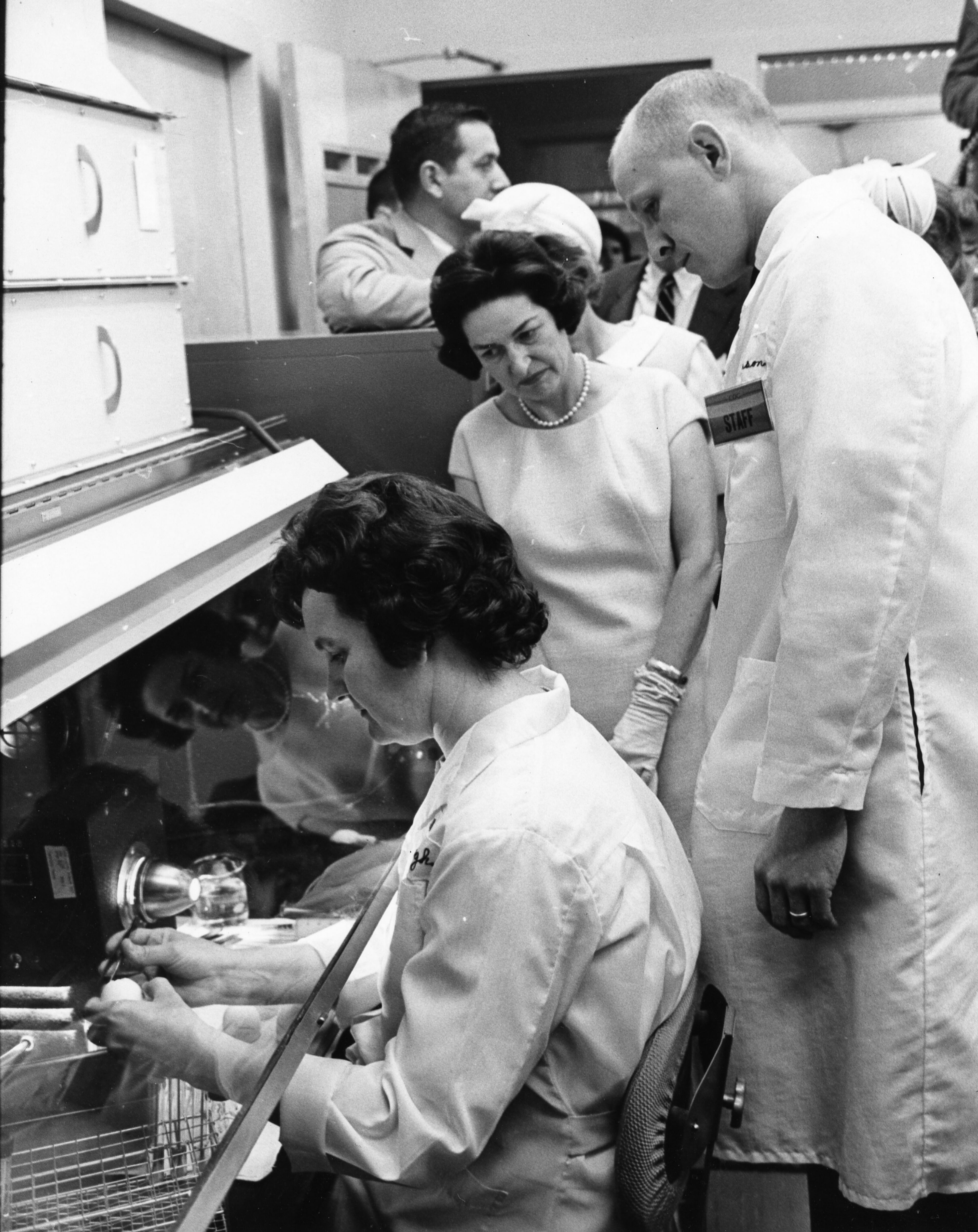 May 12 -- First Lady Mrs. Lady Bird Johnson tours the U.S. Public Health Service Communicable Disease Center. She is standing next to Dr. Robinson (at right). She was there to break ground for a new auditorium.
