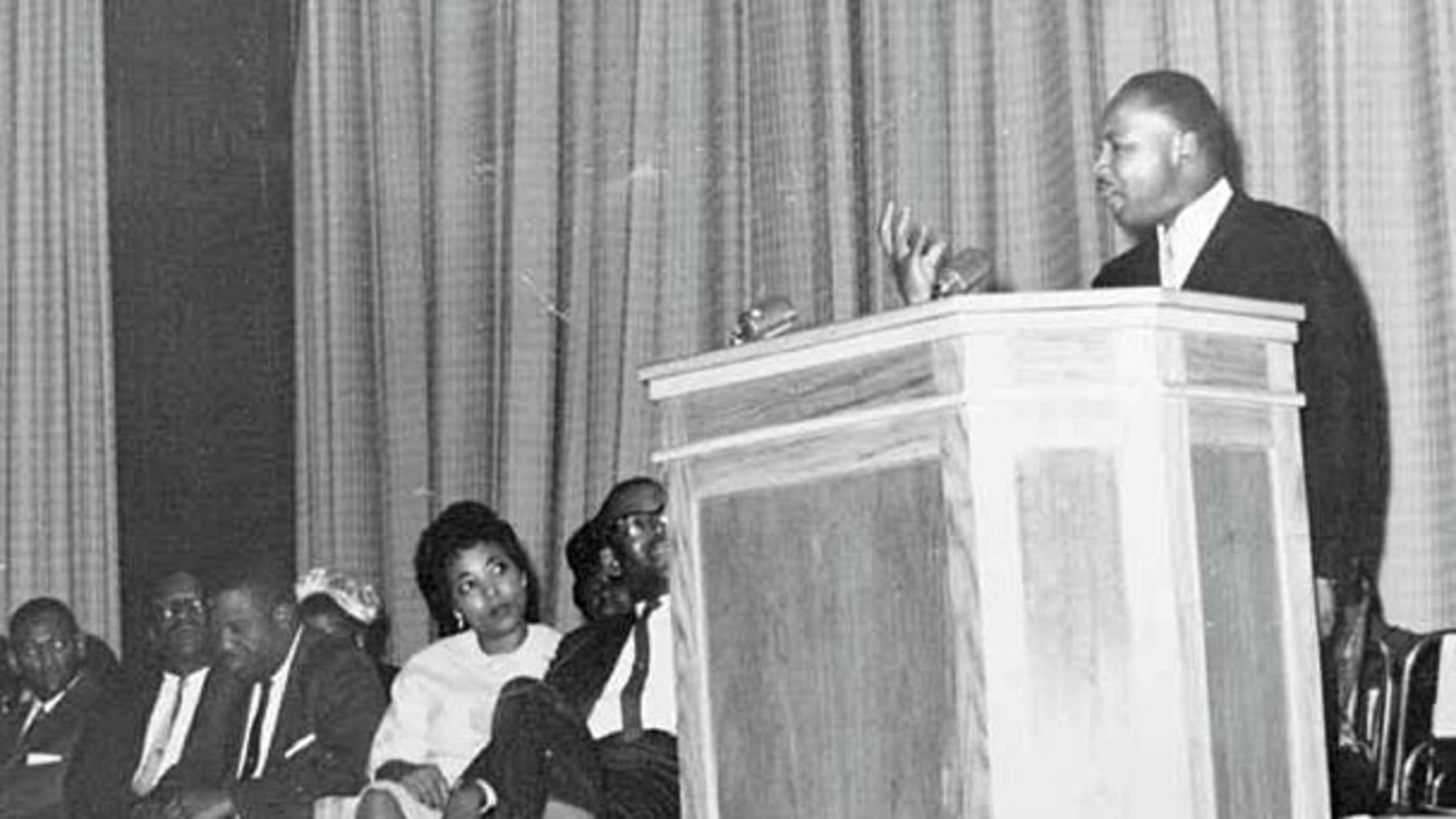 Dorothy Cotton as a young woman listens to a speech by Martin Luther King Jr.