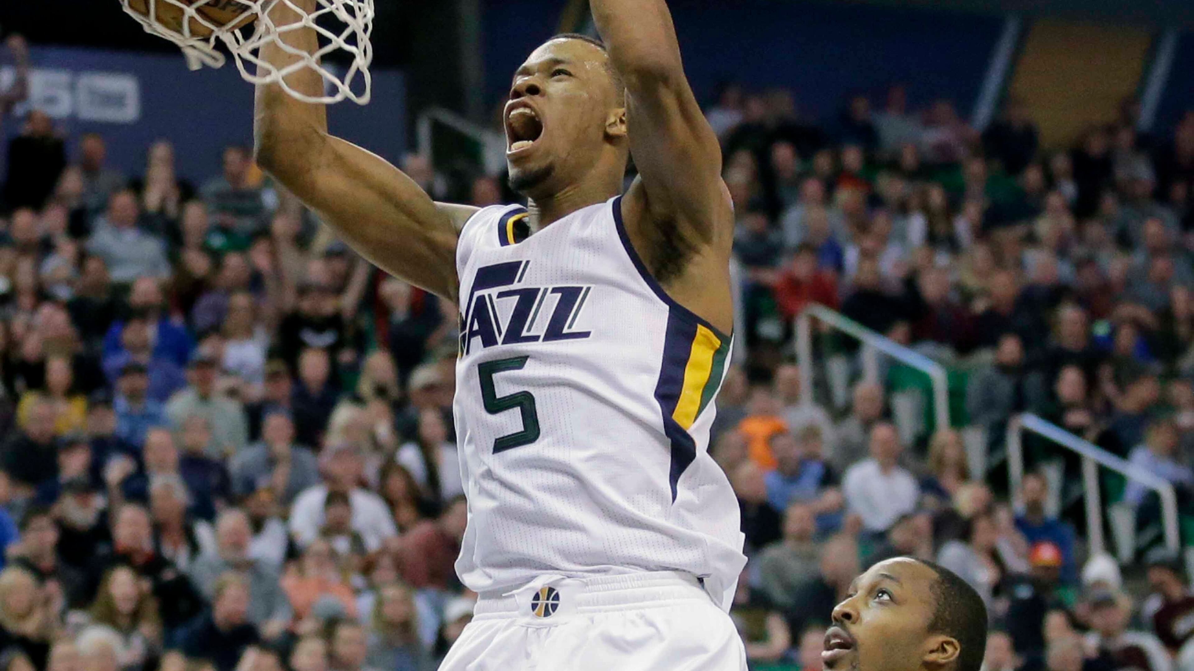 Utah Jazz guard Rodney Hood (5) dunks the ball as Atlanta Hawks center Dwight Howard (8) looks on in the second half during an NBA basketball game Friday, Nov. 25, 2016, in Salt Lake City. The Jazz won 95-68. (AP Photo/Rick Bowmer)