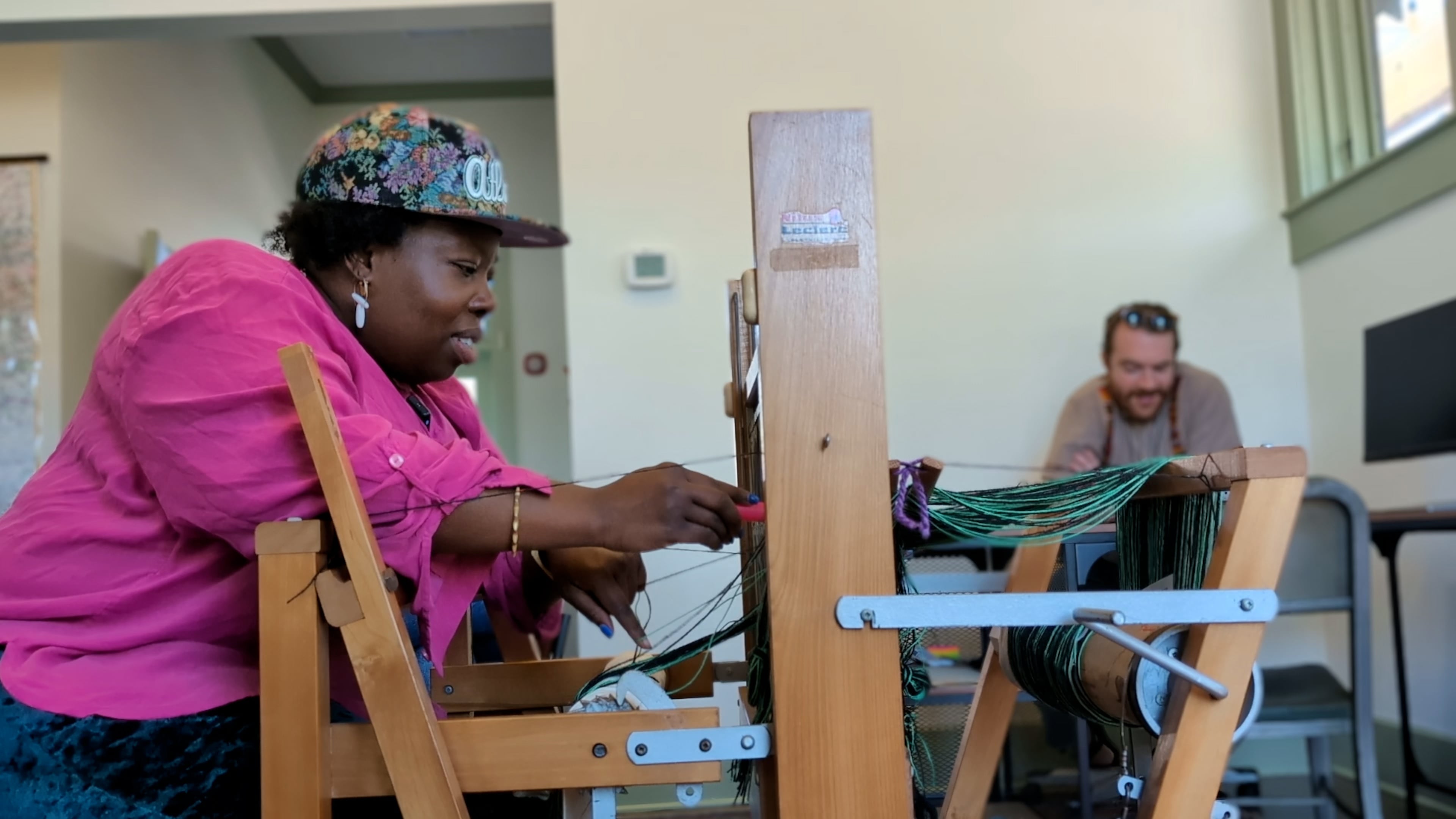 Textile artist Camisha Butler, pictured here with volunteer David Harris, worked with historian Nedra Deadwyler on the Hapeville Depot Museum's exhibit on Plunkett Town, a predominantly Black neighborhood that was bulldozed to make way for an airport expansion. (Courtesy of Hapeville Depot Museum)