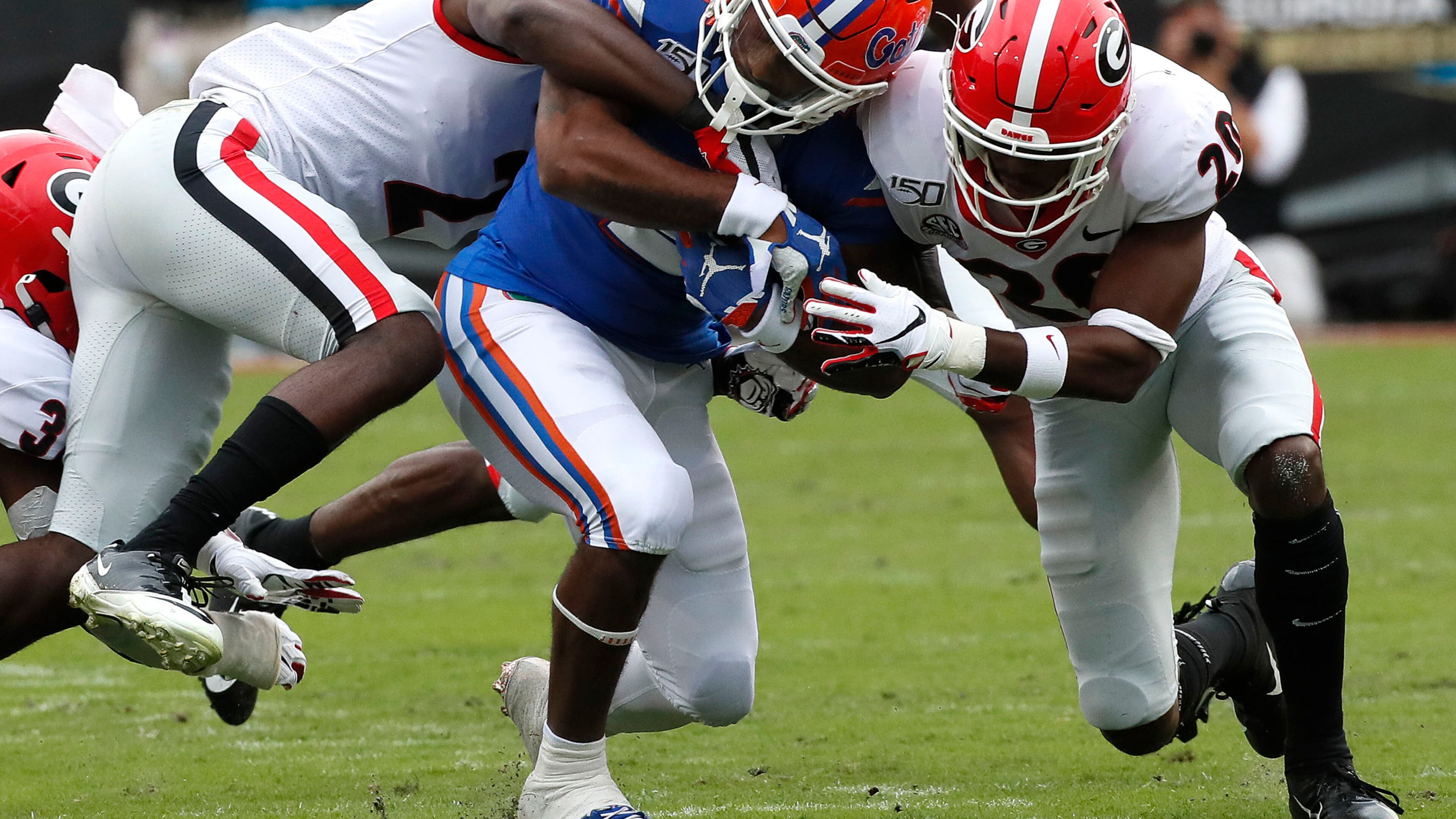 A pack of Bulldogs combine to stop Florida running back Lamical Perine Saturday in Jacksonville. (BOB ANDRES / ROBERT.ANDRES@AJC.COM)