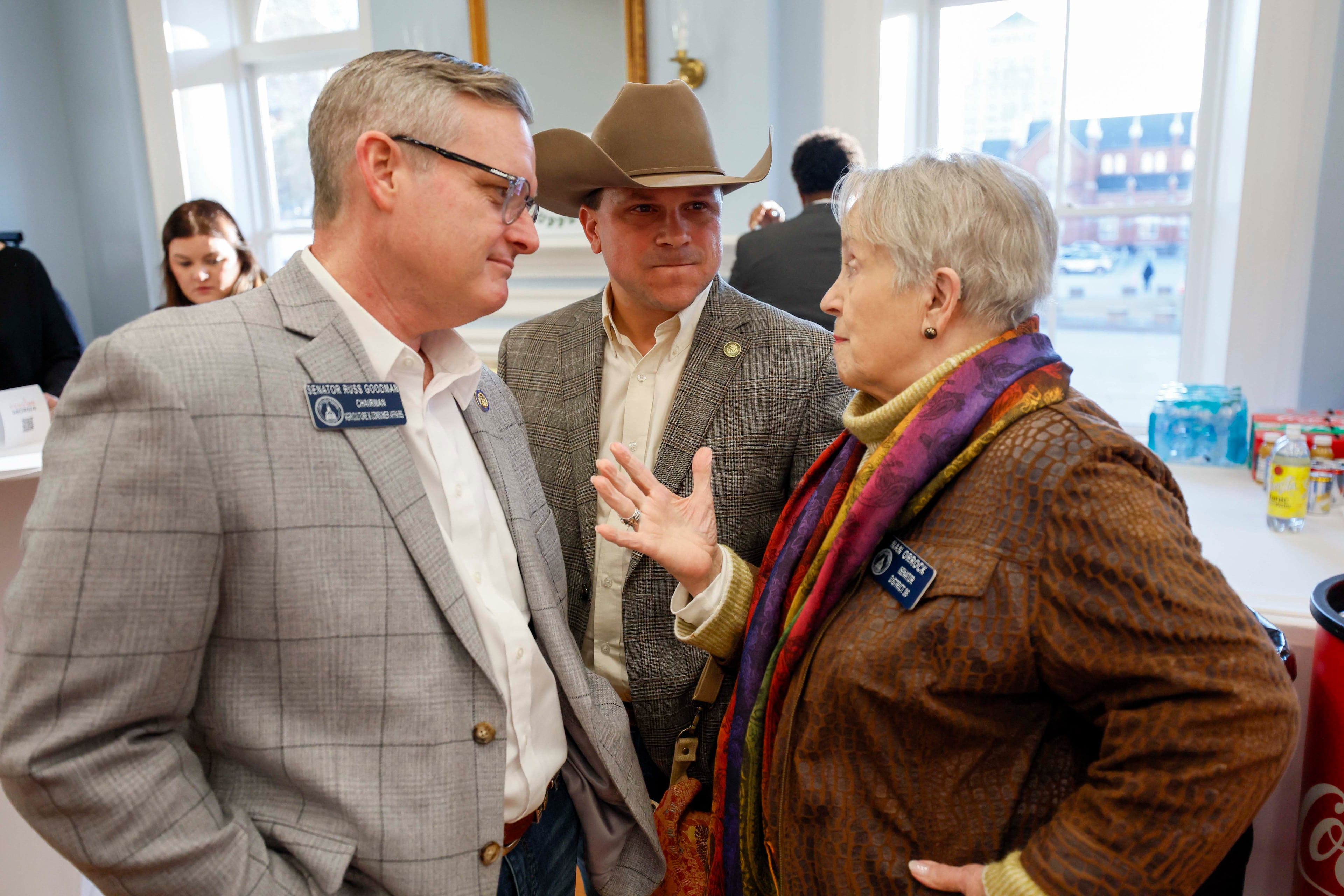 Conversations crossed party lines as state Sen. Nan Orrock, D-Atlanta, chats with state Sen. Russ Goodman, R-Cogdell, and Commissioner of Agriculture Tyler J. Harper. (Miguel Martinez/AJC)