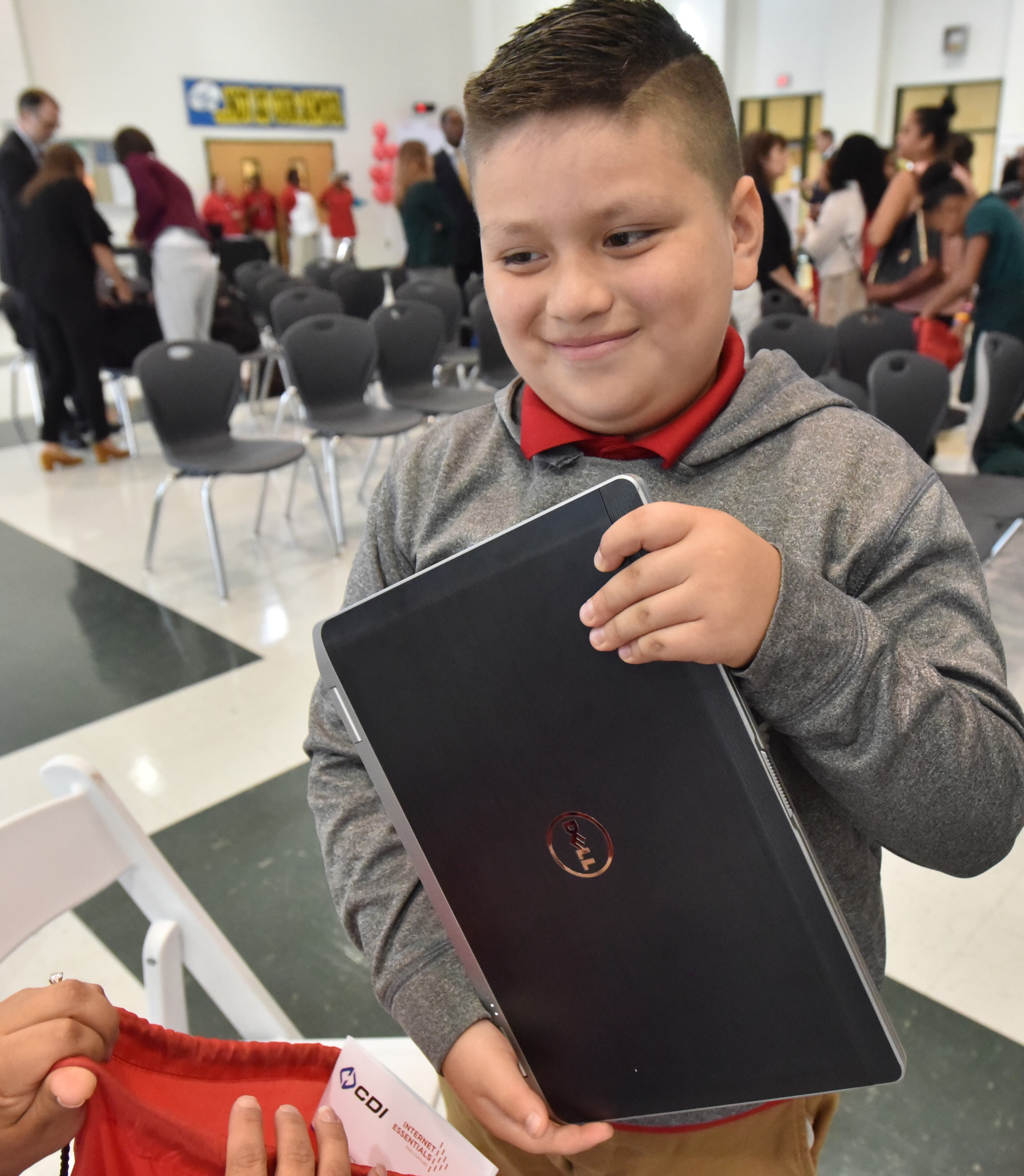 October 4, 2017 Morrow - Edgar Sanchez, 10, shows off his laptop during Internet Essentials Back to School Event at Morrow Middle School on Wednesday, October 4, 2017. Comcast's community investment program, Internet Essentials, is now in its seventh academic year and is most successful broadband adoption initiative for low-income families. Comcast also announced it is donating 100 laptops to students at Morrow Middle School and Unidos Dual Language Charter School, located in the Clayton County School District. HYOSUB SHIN / HSHIN@AJC.COM