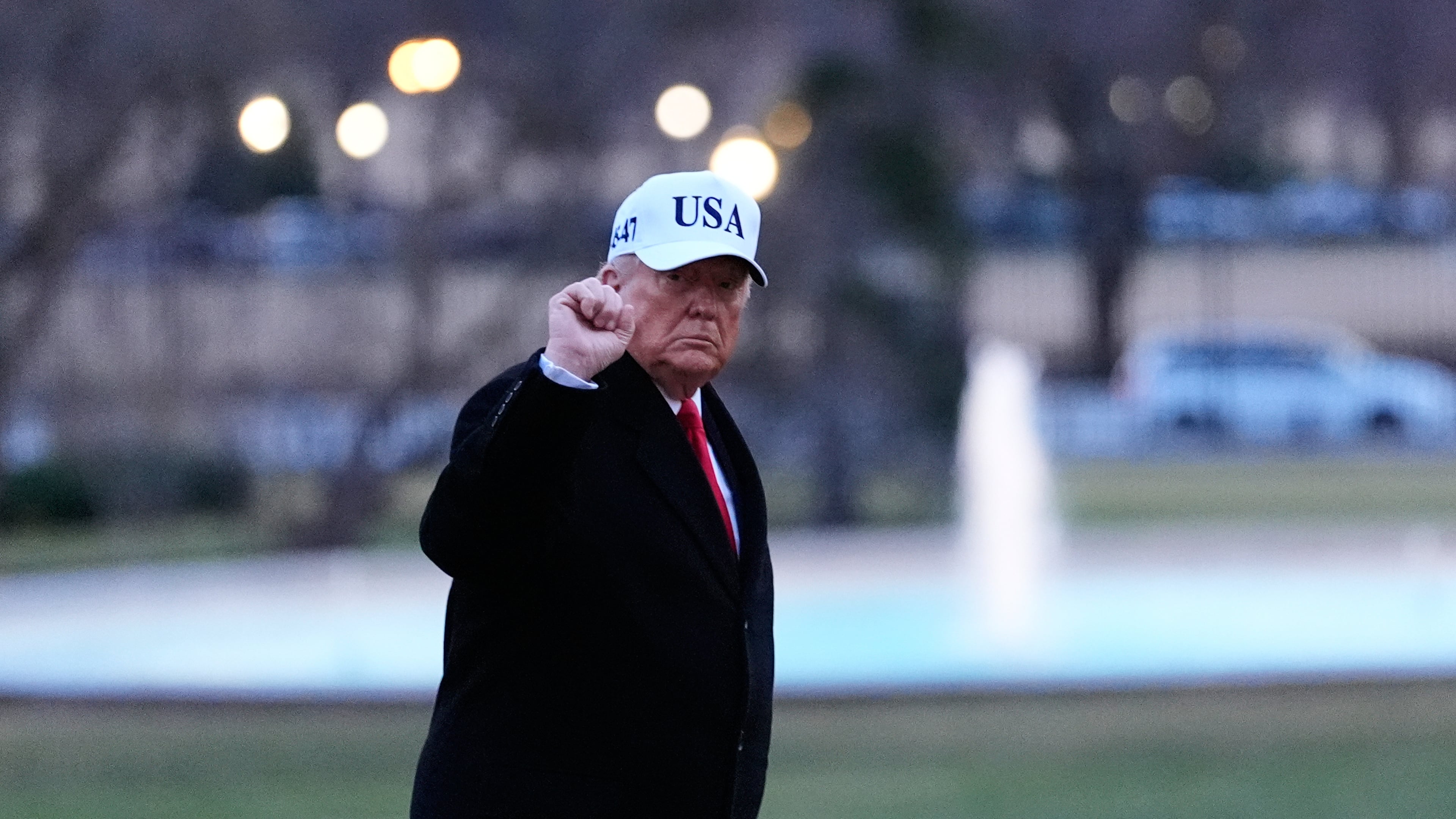 President Donald Trump gestures as he walks from Marine One after arriving on the South Lawn of the White House, Tuesday, Jan. 13, 2026, in Washington. (AP Photo/Alex Brandon)