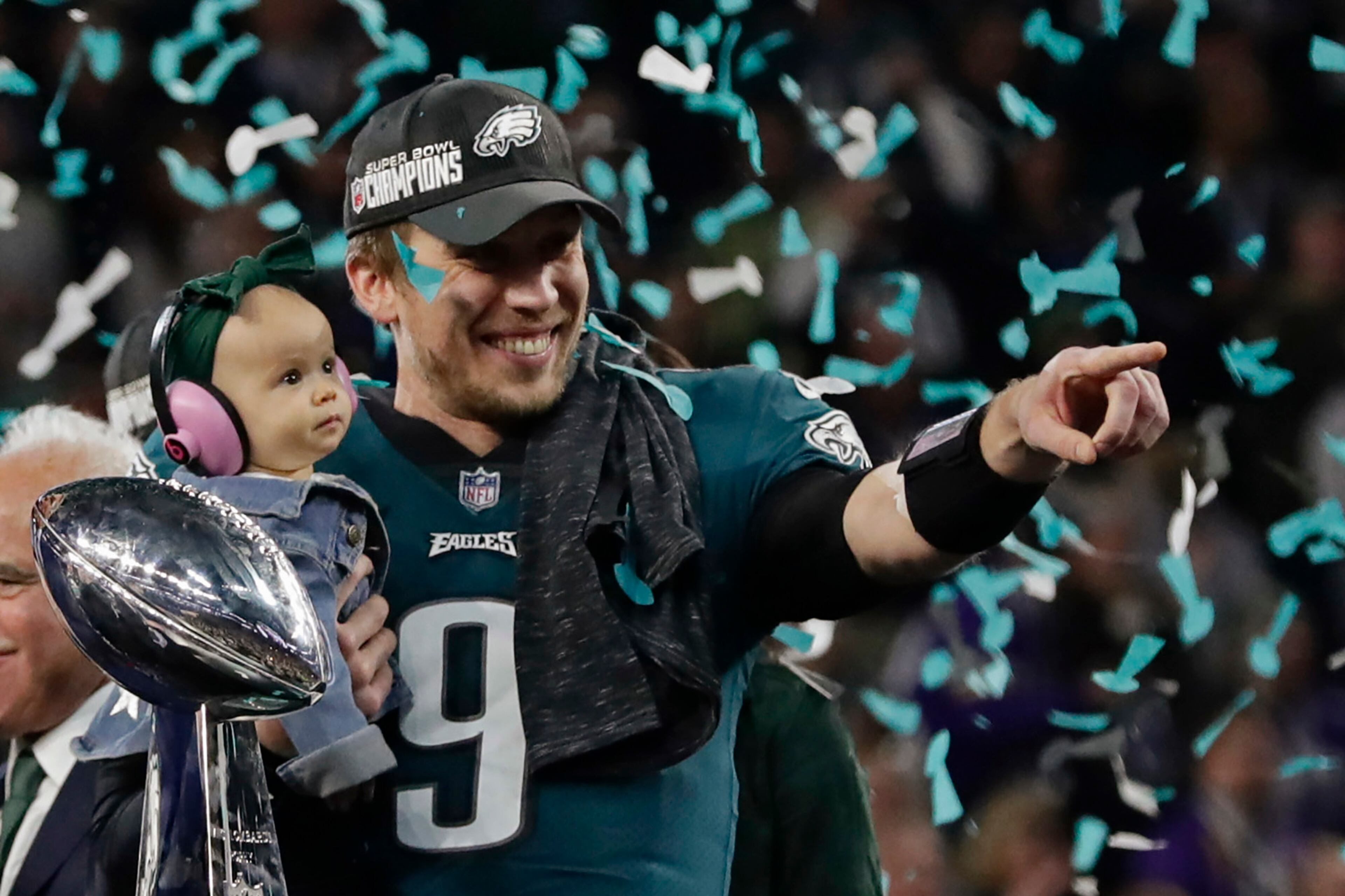Philadelphia Eagles quarterback Nick Foles (9) holds his daughter, Lily James, after winning the NFL Super Bowl 52 football game against the New England Patriots, Sunday, Feb. 4, 2018, in Minneapolis. The Eagles won 41-33. (AP Photo/Frank Franklin II)