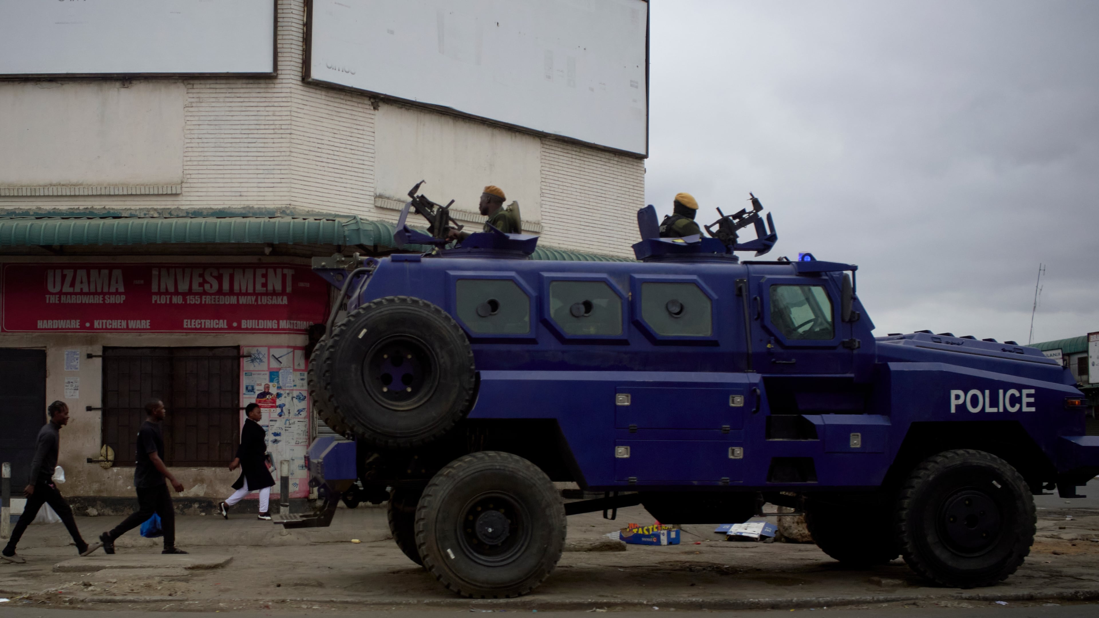 A police vehicle is parked on a sidewalk, on the outskirts of Lusaka, Zambia, Friday, Aug. 14, 2026. (AP Photo/Alfonso Nqunjana)