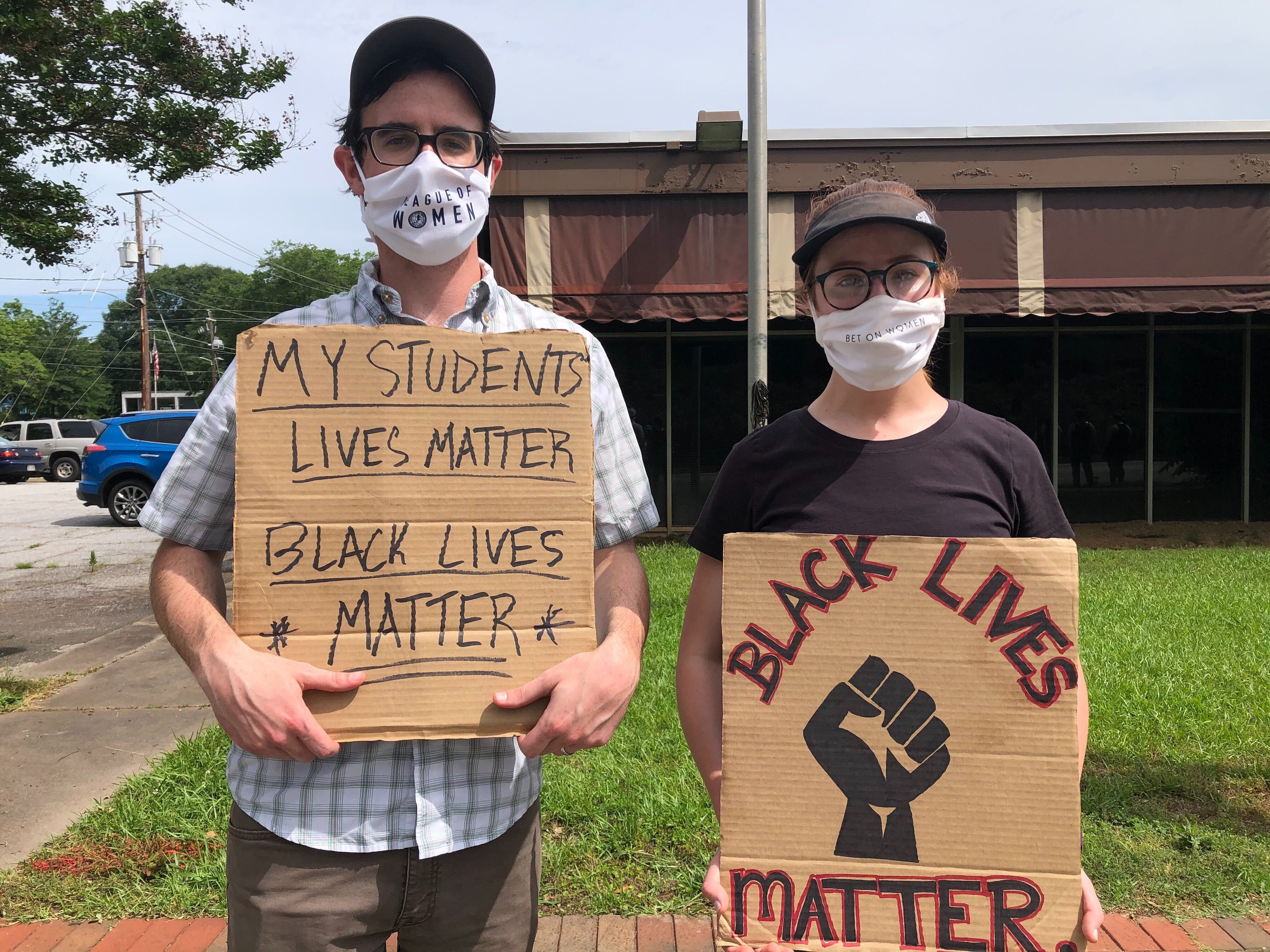 Elizabeth and Mark Hammontree, both 25, attended the rally Saturday in Avondale Estates. (Photo: Helena Oliviero/AJC)
