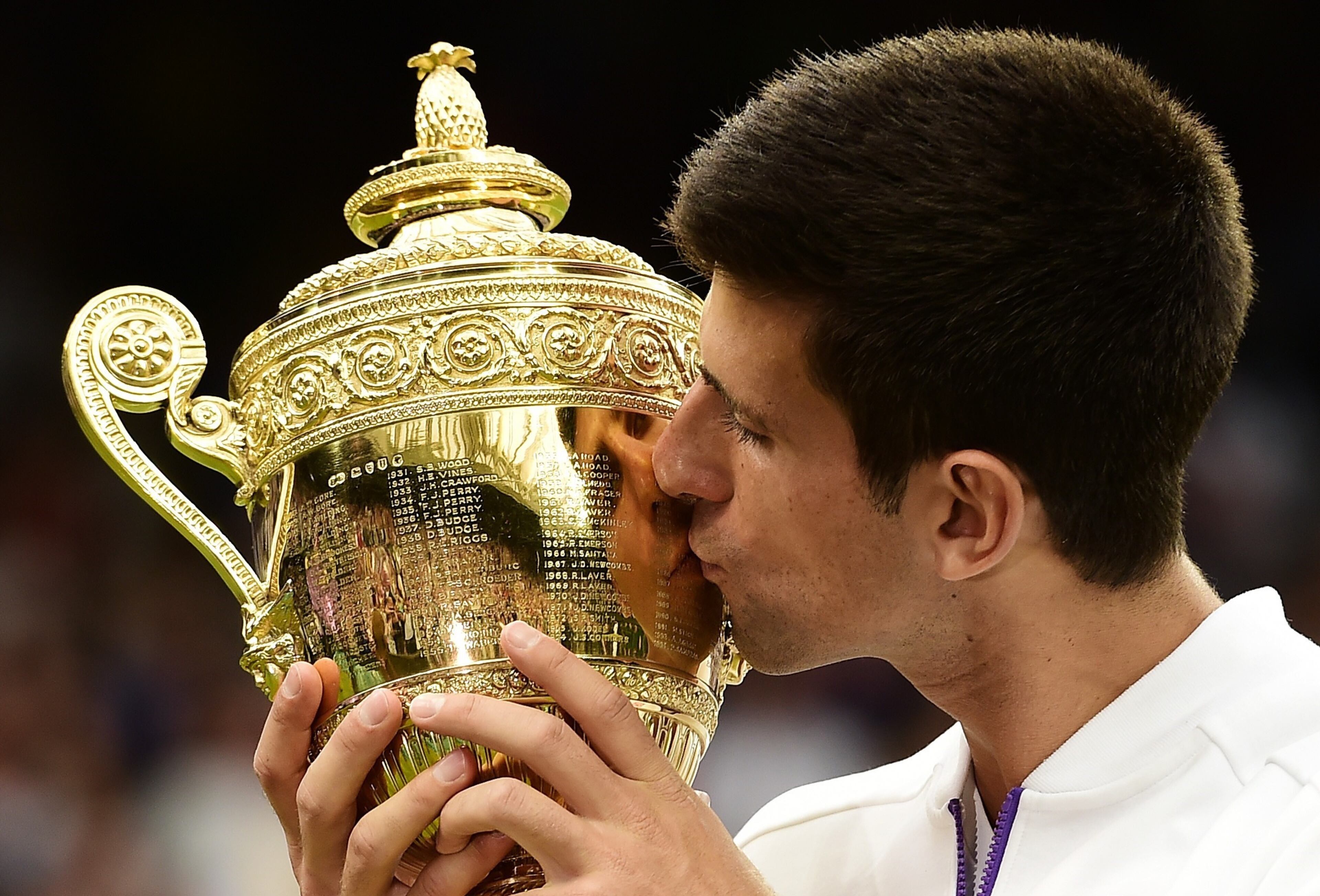 LONDON, ENGLAND - JULY 12: Novak Djokovic celebrates with the trophy after victory over Roger Federer of Switzerland in the Gentleman's Singles Final during day thirteen of the Wimbledon Lawn Tennis Championships at the All England Lawn Tennis and Croquet Club on July 12, 2015 in London, England. (Photo by Alex Broadway/Anadolu Agency/Getty Images)