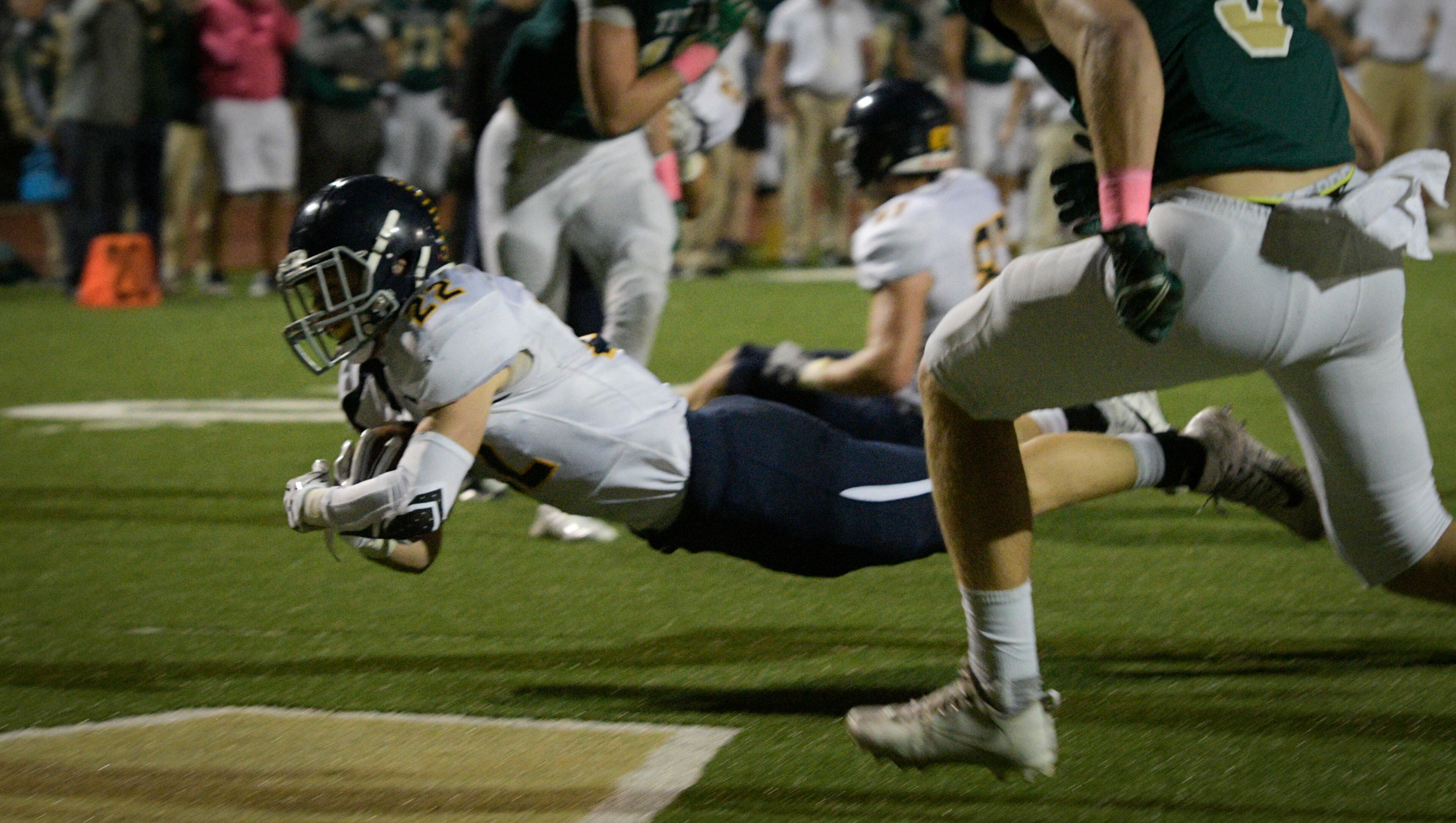 Marist's Dean Johnson dives for a TD against Blessed Trinity during a high school football game, Friday, Oct. 20, 2017, in Roswell. (John Amis)