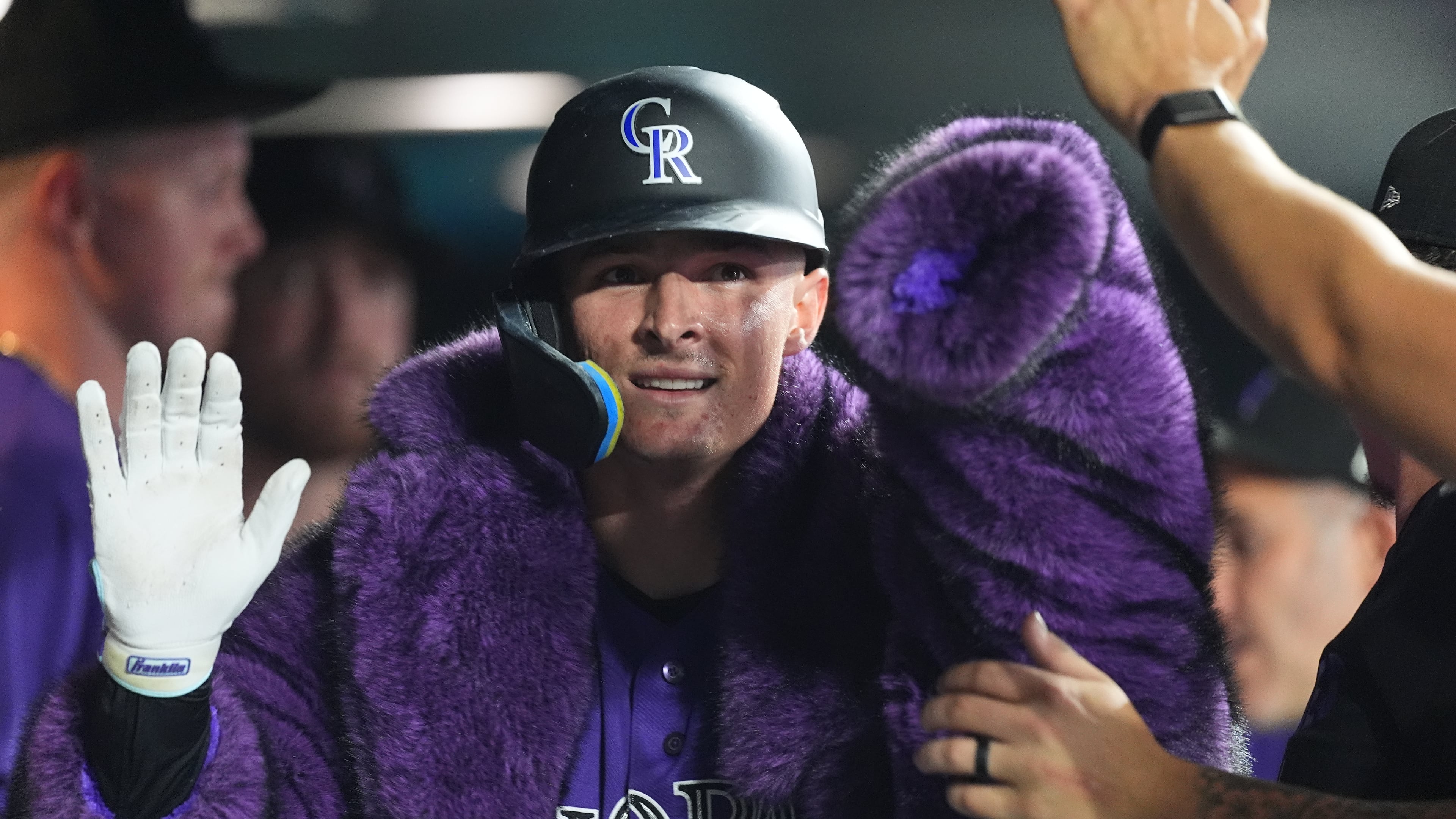 Colorado Rockies' Mickey Moniak is congratulated as he returns to the dugout after hitting a solo home run off Tampa Bay Rays relief pitcher Michael Grove in the eighth inning of a baseball game Monday, Aug. 3, 2026, in Denver. (AP Photo/David Zalubowski)