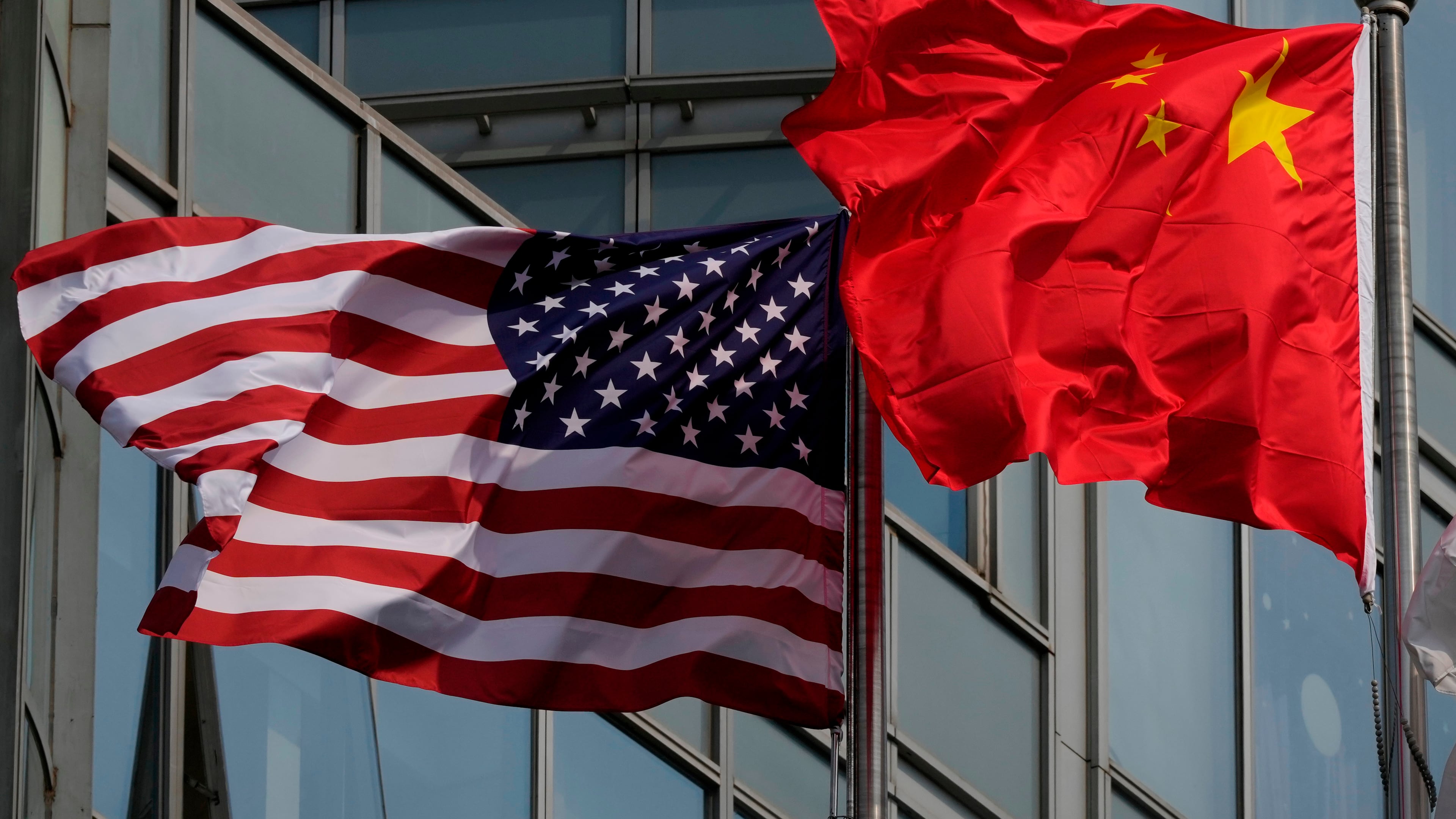 The United States and Chinese flags are flown outside a hotel expected to be used for U.S. President Donald Trump's visit to Beijing Wednesday, May 13, 2026. (AP Photo/Ng Han Guan)