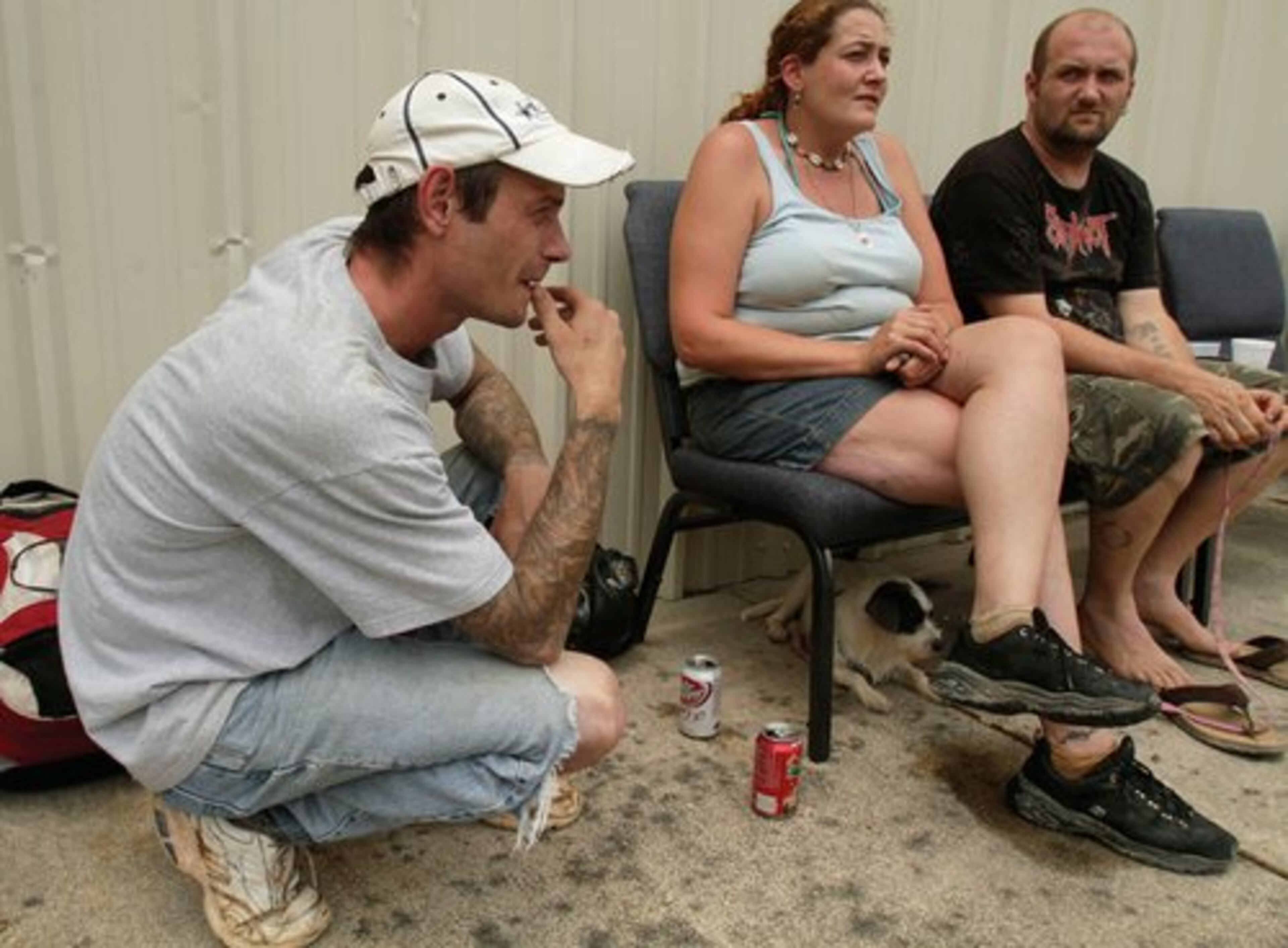 From left, Chad Banks, Lorraine Smith and Joe McBay of Texarkana, Ark., rest at a church near Caddo Gap on Friday after they were rescued from a nearby campground.