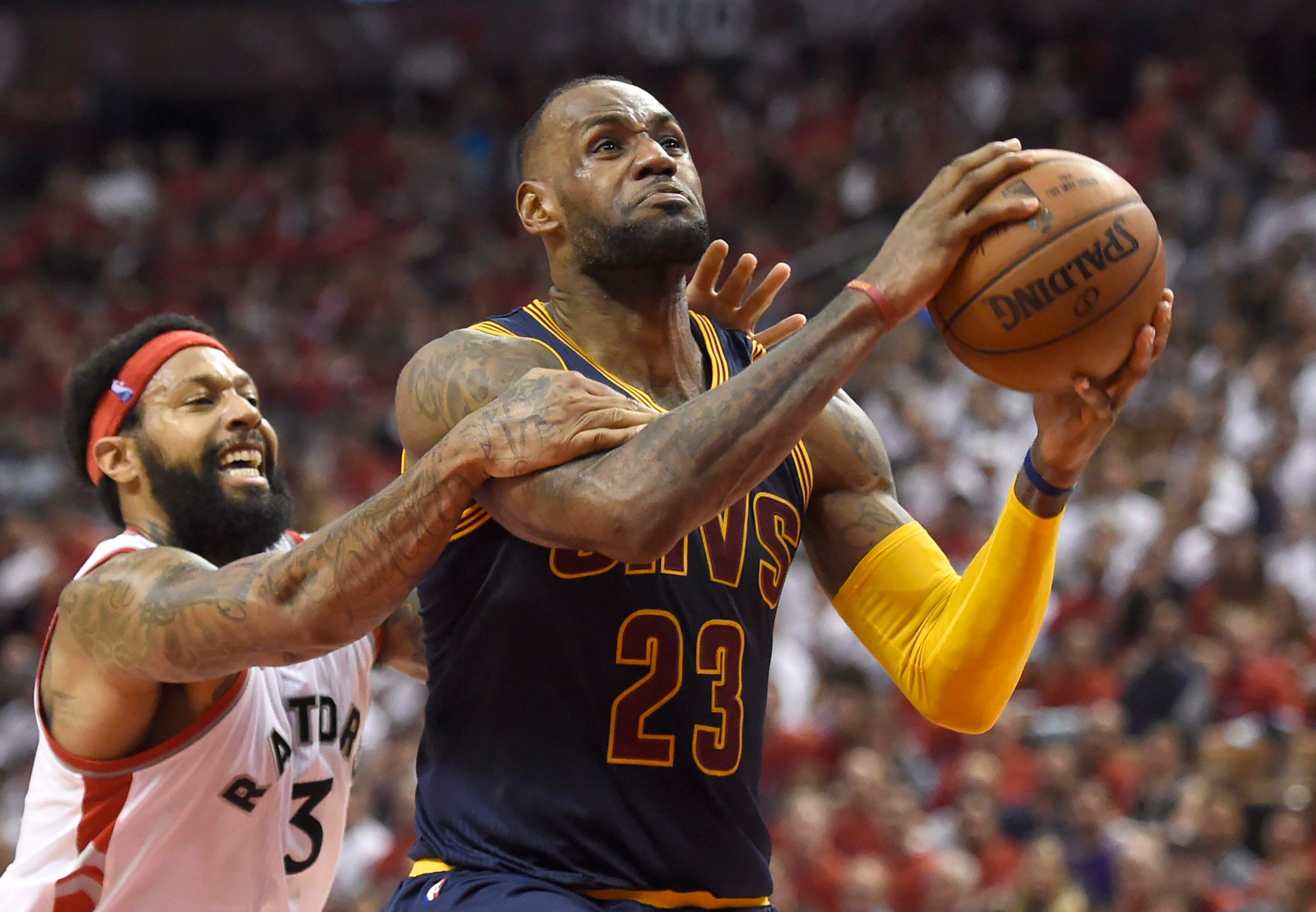 HEADED TO THE FINALS--Toronto Raptors forward James Johnson fouls Cleveland Cavaliers forward LeBron James late in the fourth quarter of Game 6 of the NBA basketball Eastern Conference finals, Friday, May 27, 2016, in Toronto. The Cavaliers won 113-87 and advanced to the NBA Finals. (Frank Gunn/The Canadian Press via AP)