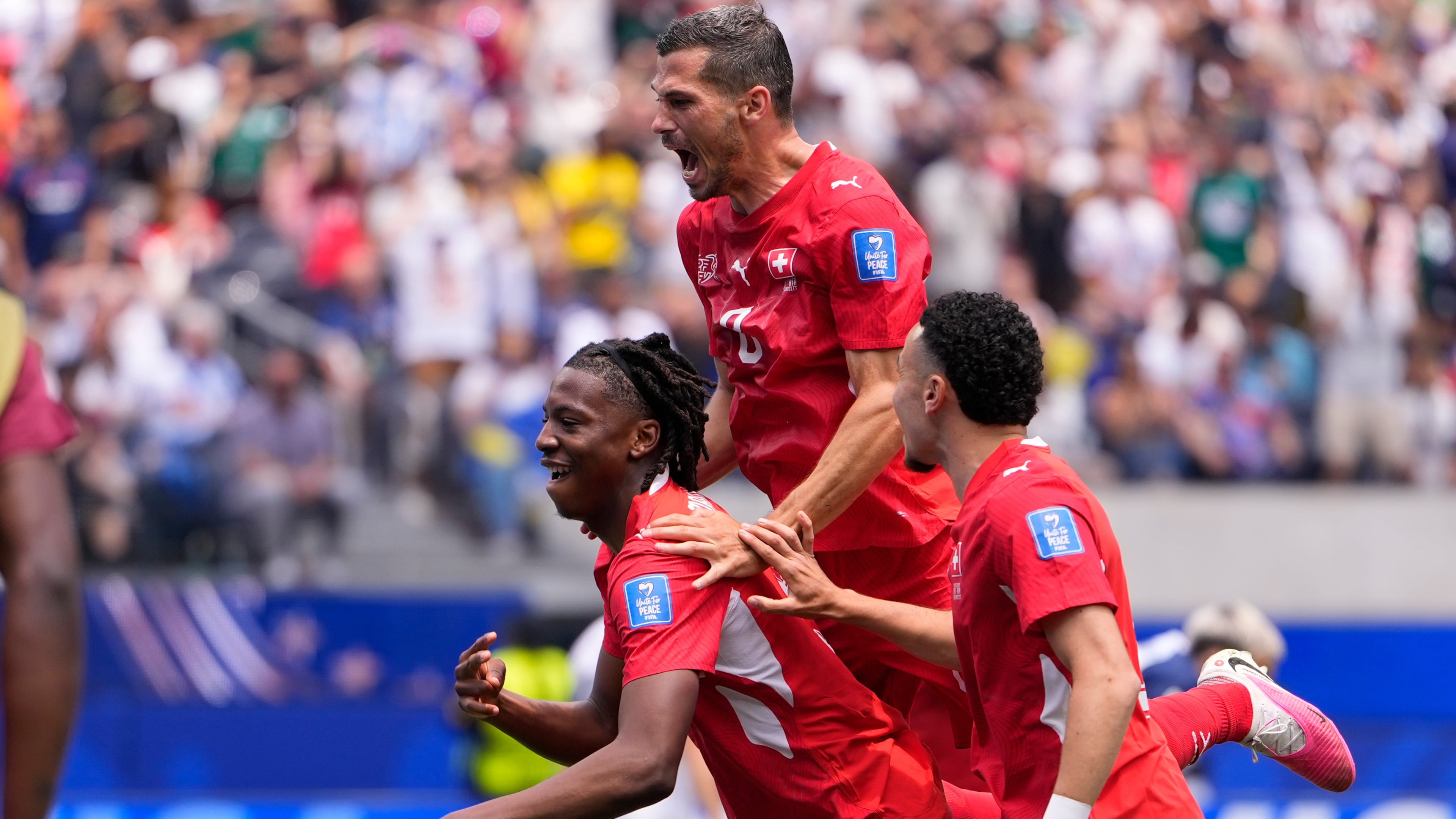 Switzerland's Johan Manzambi, left, celebrates with teammates after scoring the opening goal against Bosnia during the World Cup Group B soccer match in Inglewood, Calif., near Los Angeles, Thursday, June 18, 2026. (AP Photo/Mark J. Terrill)
