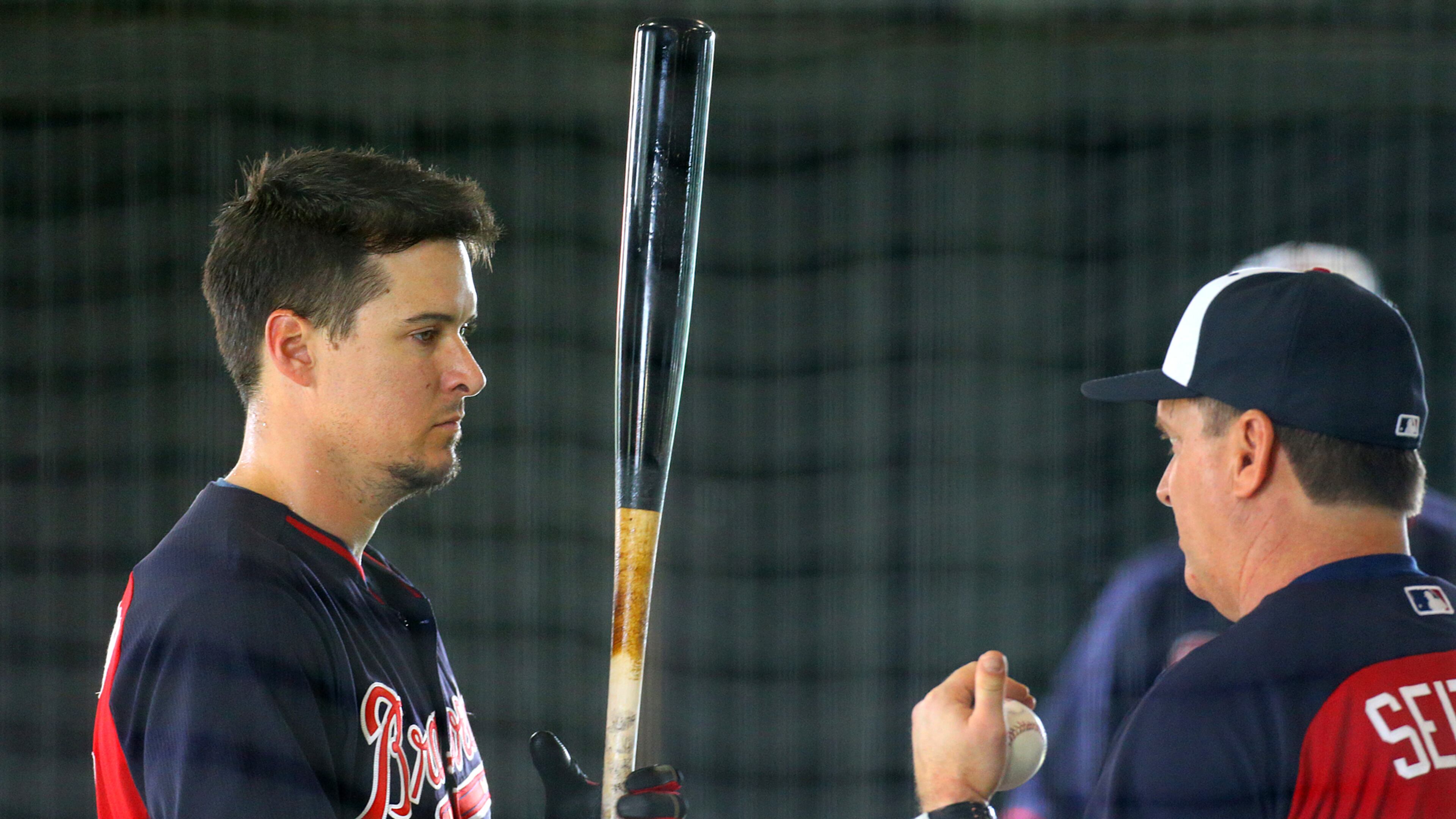 Braves infielder Kelly Johnson works on his swing with hitting coach Kevin Seitzer in the batting tunnels during spring training. Curtis Compton / ccompton@ajc.com