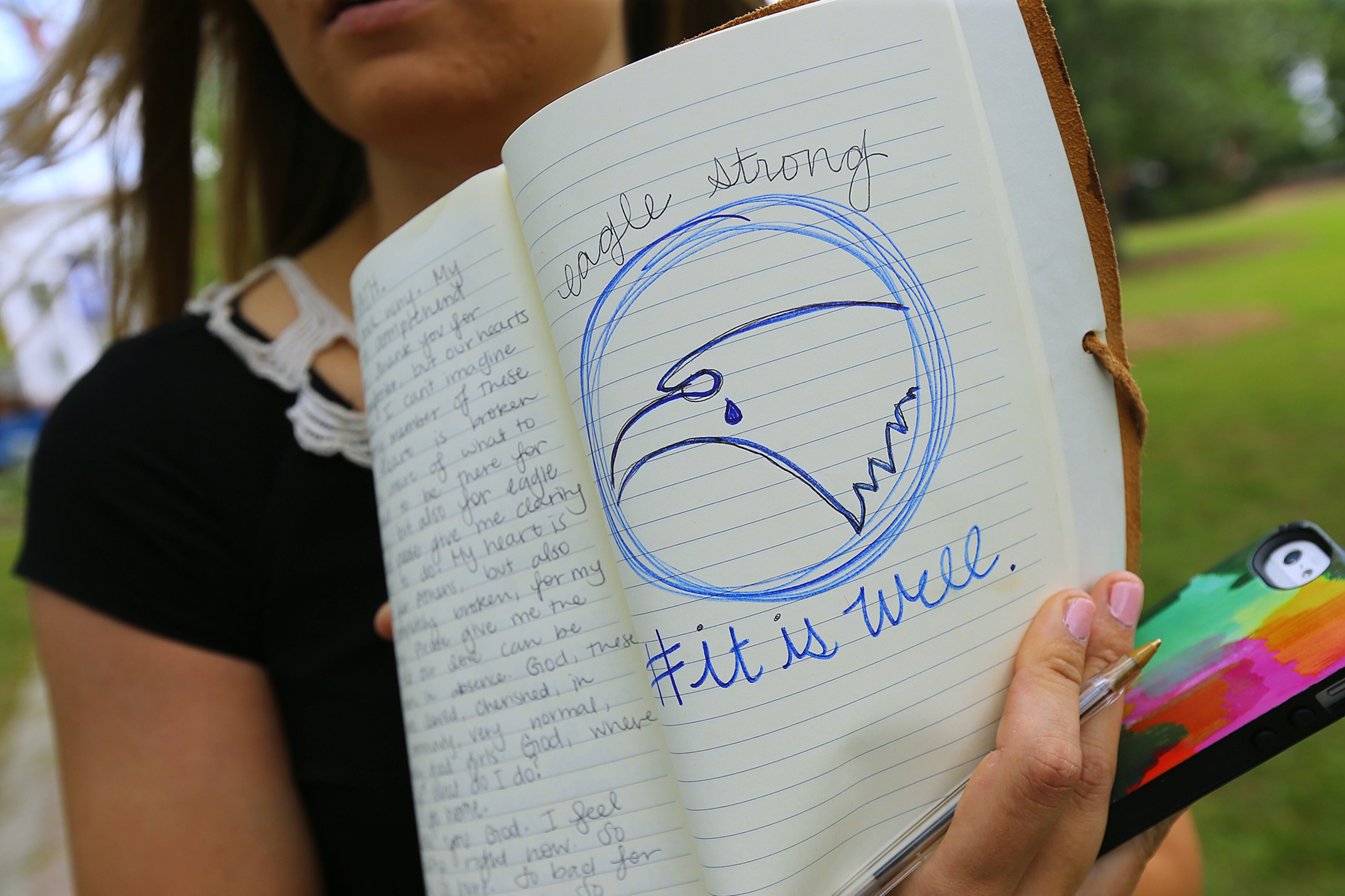 Georgia Southern University senior Katie Pursley, 21, visits the Memorial Service site on Sweetheart Circle for those students whose lives were tragically lost on Thursday, April 23, 2015, in Statesboro. Pursley, from Athens, keeps a daily journal in which she drew the school mascot, an eagle, with a tear to symbolize the grief of the university. Curtis Compton / ccompton@ajc.com