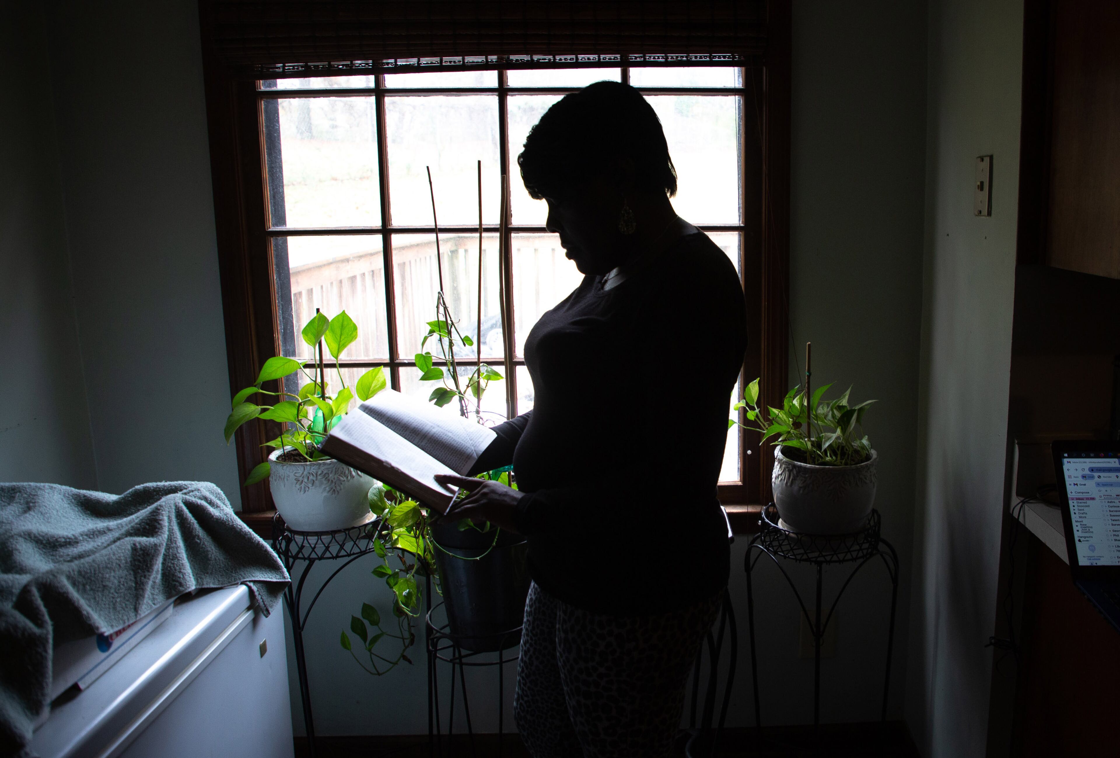 A client of the federal Housing Opportunities for Persons with AIDS program looks out the front door of the Ellenwood house where she was staying on Sunday, December 23, 2021. She is homeless after her case fell through the cracks of the city of Atlanta-run program. STEVE SCHAEFER FOR THE ATLANTA JOURNAL-CONSTITUTION STEVE SCHAEFER FOR THE ATLANTA JOURNAL-CONSTITUTION