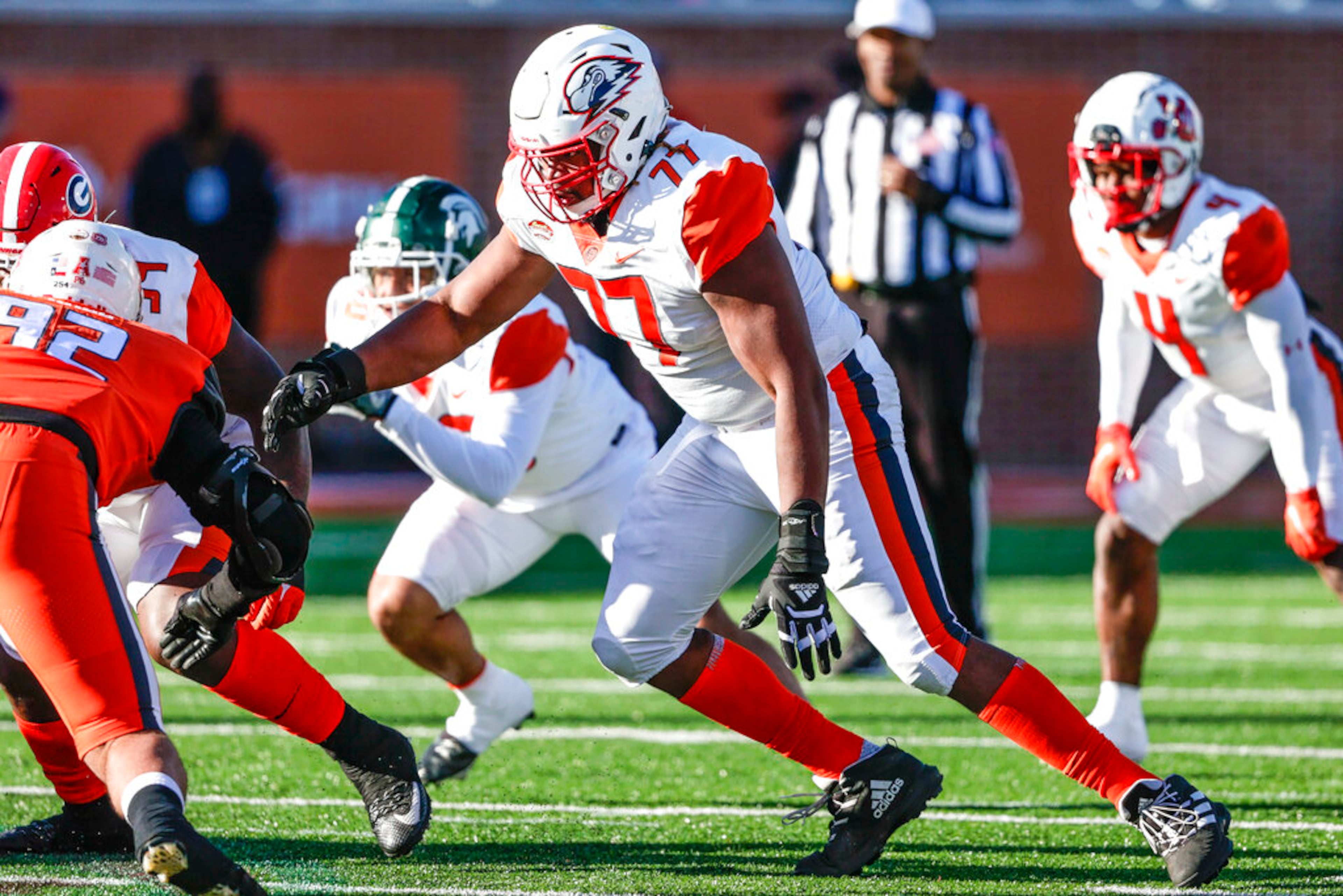 American Team offensive lineman Braxton Jones of Southern Utah (77) sets a block at the snap during the third quarter of an NCAA Senior Bowl college football game, Saturday, Feb. 5, 2022, in Mobile, Ala. (AP Photo/Butch Dill)
