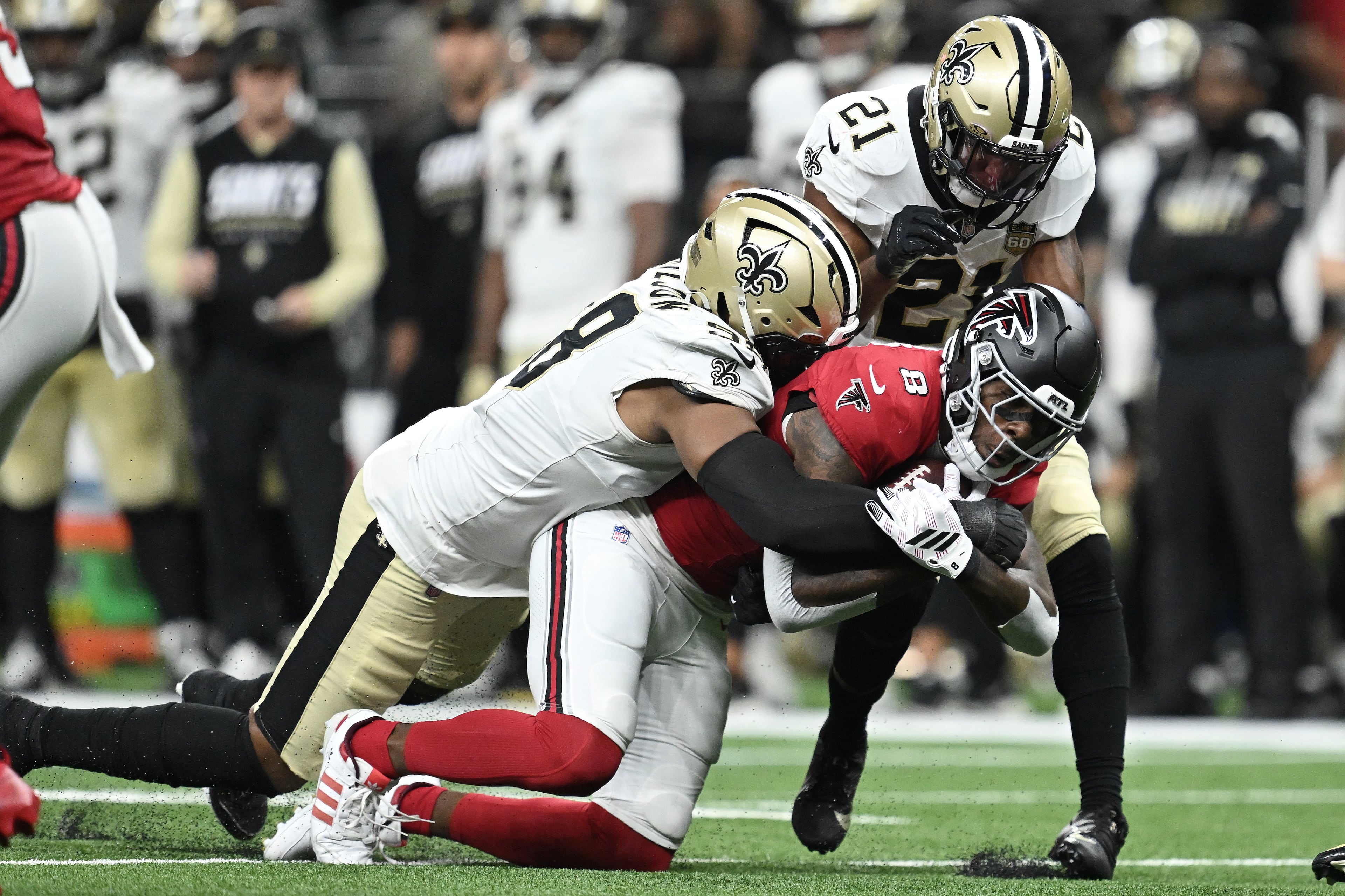 Atlanta Falcons tight end Kyle Pitts Sr. (right) is tackled by New Orleans Saints defensive end Tyree Wilson (left) and safety Justin Reid during the first half of an NFL football game in New Orleans, Monday, Oct. 5, 2026. (Ella Hall/AP)