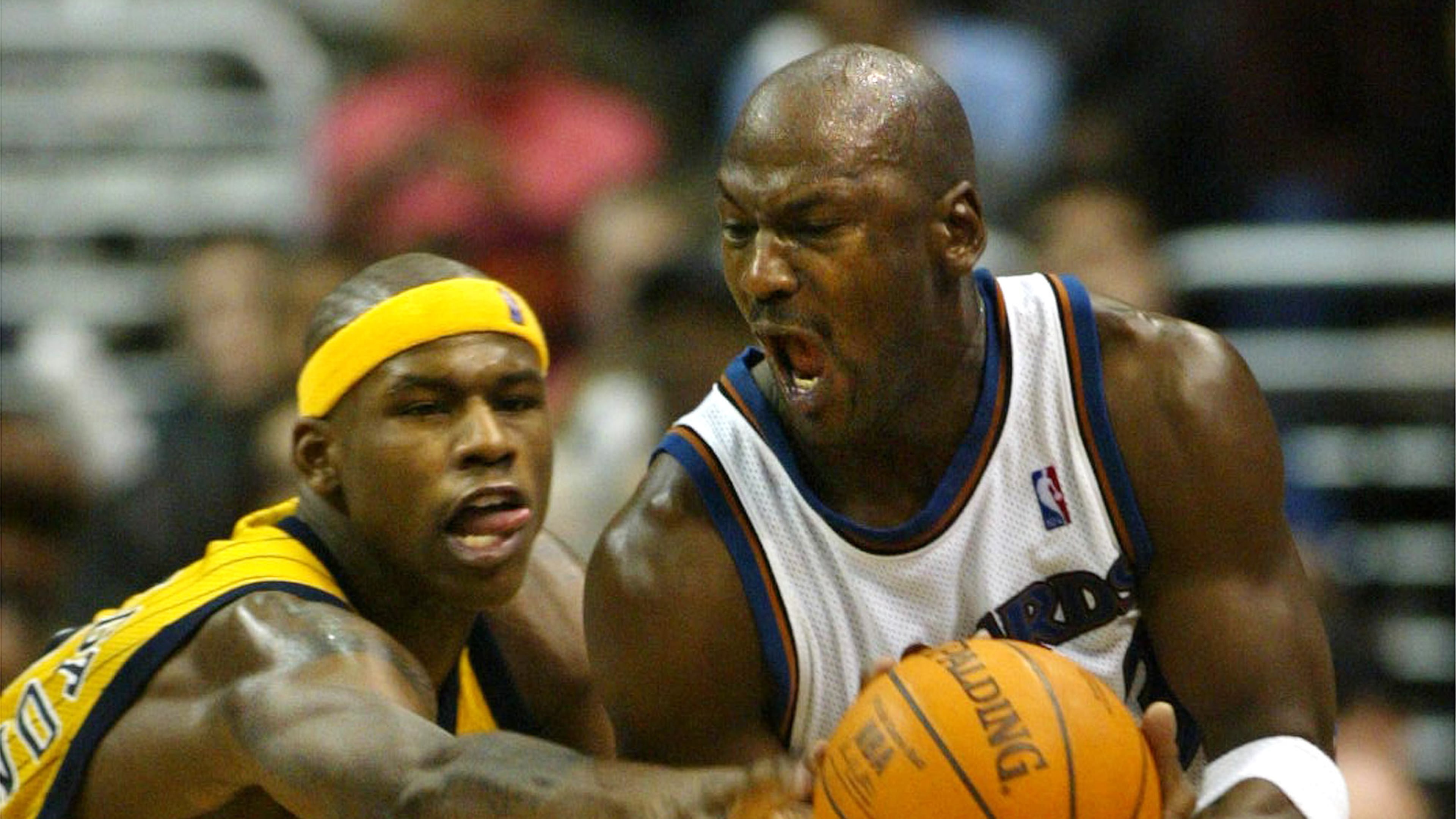 FILE - Washington Wizards' Michael Jordan gets control of the ball with pressure from Indiana Pacers' Al Harrington in the fourth quarter of play, Jan. 4, 2003, in Washington. (AP PHoto/Lawrence Jackson, File)