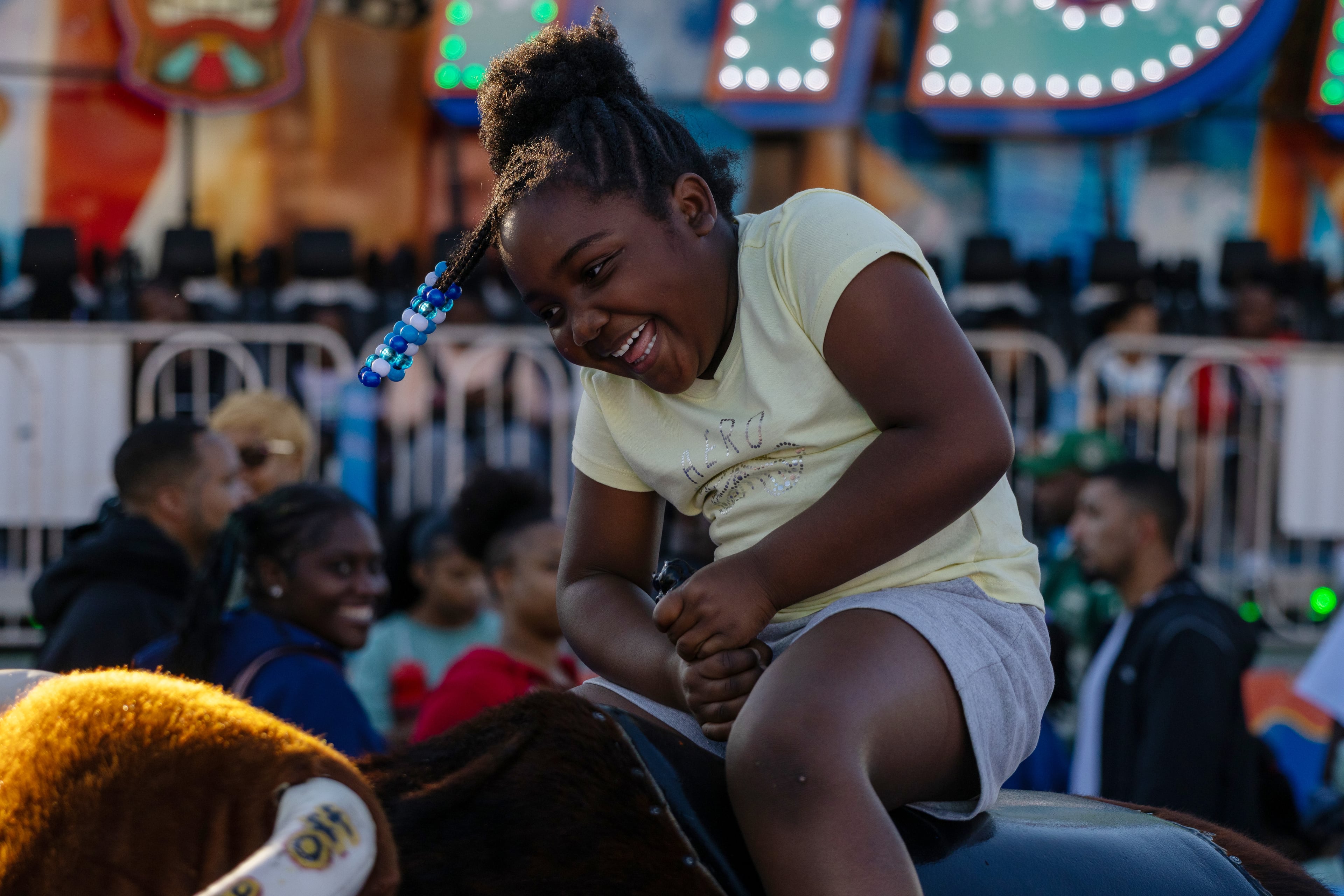 Heavyn Garrett laughs as she rides the mechanical bull at the 37th annual Georgia National Fair on Saturday, October 17, 2026. This was Garrett's first year in attendance, her family drove over two hours away from Bacon County, Georgia, to spend the day at the fair. (Wesley Webb/UGA Photojournalism Workshop)