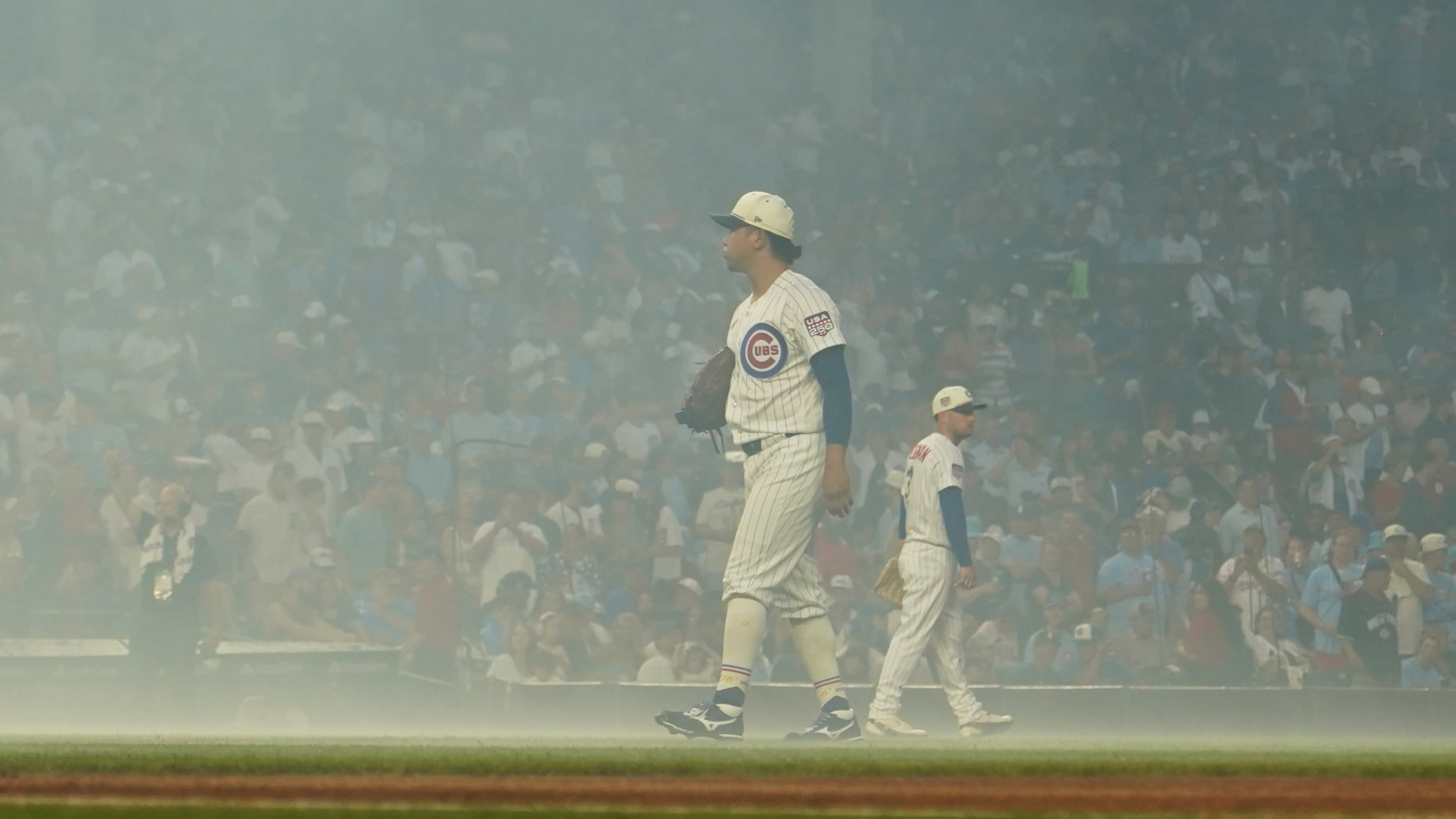 Chicago Cubs pitcher Shota Imanaga stands amidst smoke after fireworks before a baseball game against the St. Louis Cardinals, Saturday, July 4, 2026, in Chicago. (AP Photo/David Banks)