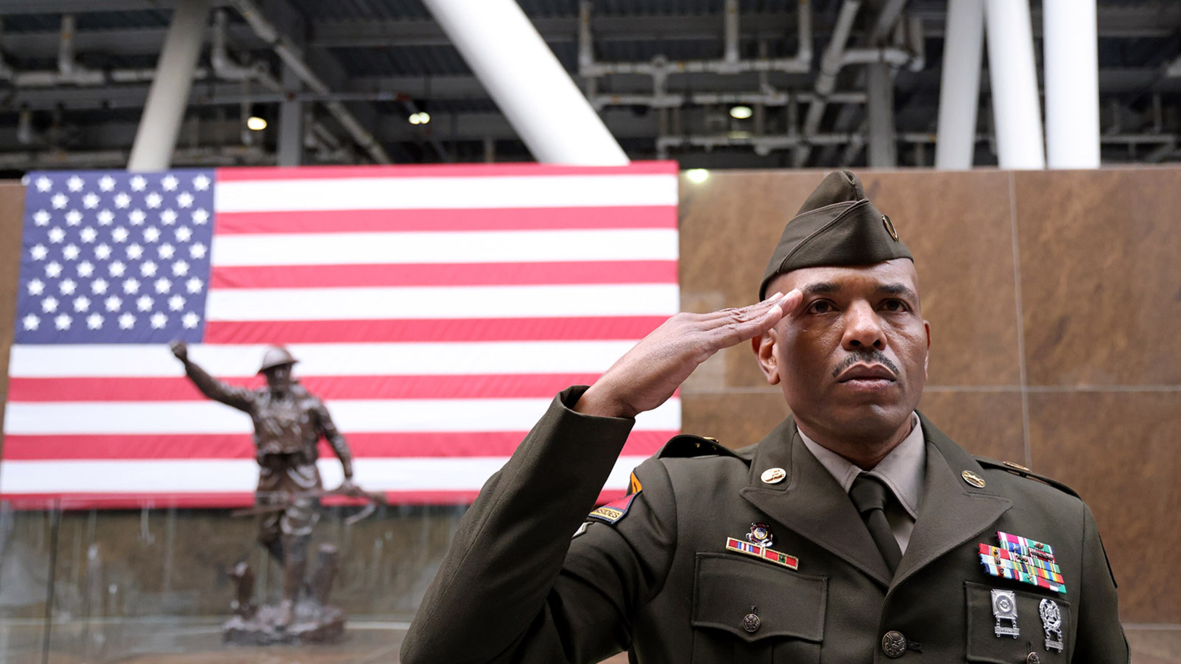 Sgt. 1st Class Keith Greenwood salutes during a Veterans Day event at Soldier Field on Nov. 11, 2022, in Chicago. Veterans Affairs plans to slash reimbursements for the ambulances that transport veterans to medical facilities. (Michael Blackshire/Chicago Tribune/TNS)