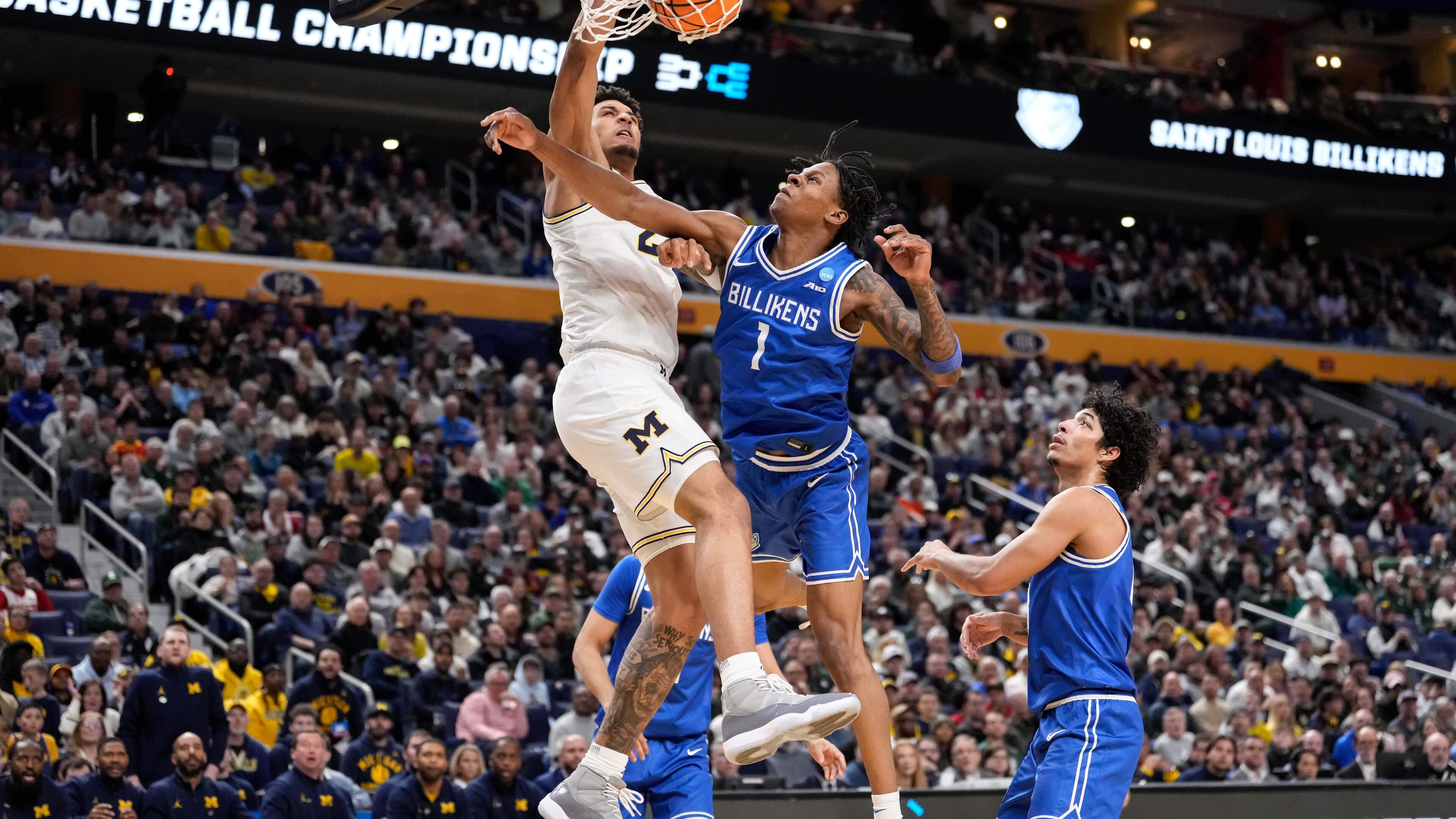 Michigan forward Yaxel Lendeborg (23) dunks over Saint Louis guard Quentin Jones (1) during the second half in the second round of the NCAA college basketball tournament, Saturday, March 21, 2026, in Buffalo, N.Y. (AP Photo/Yuki Iwamura)