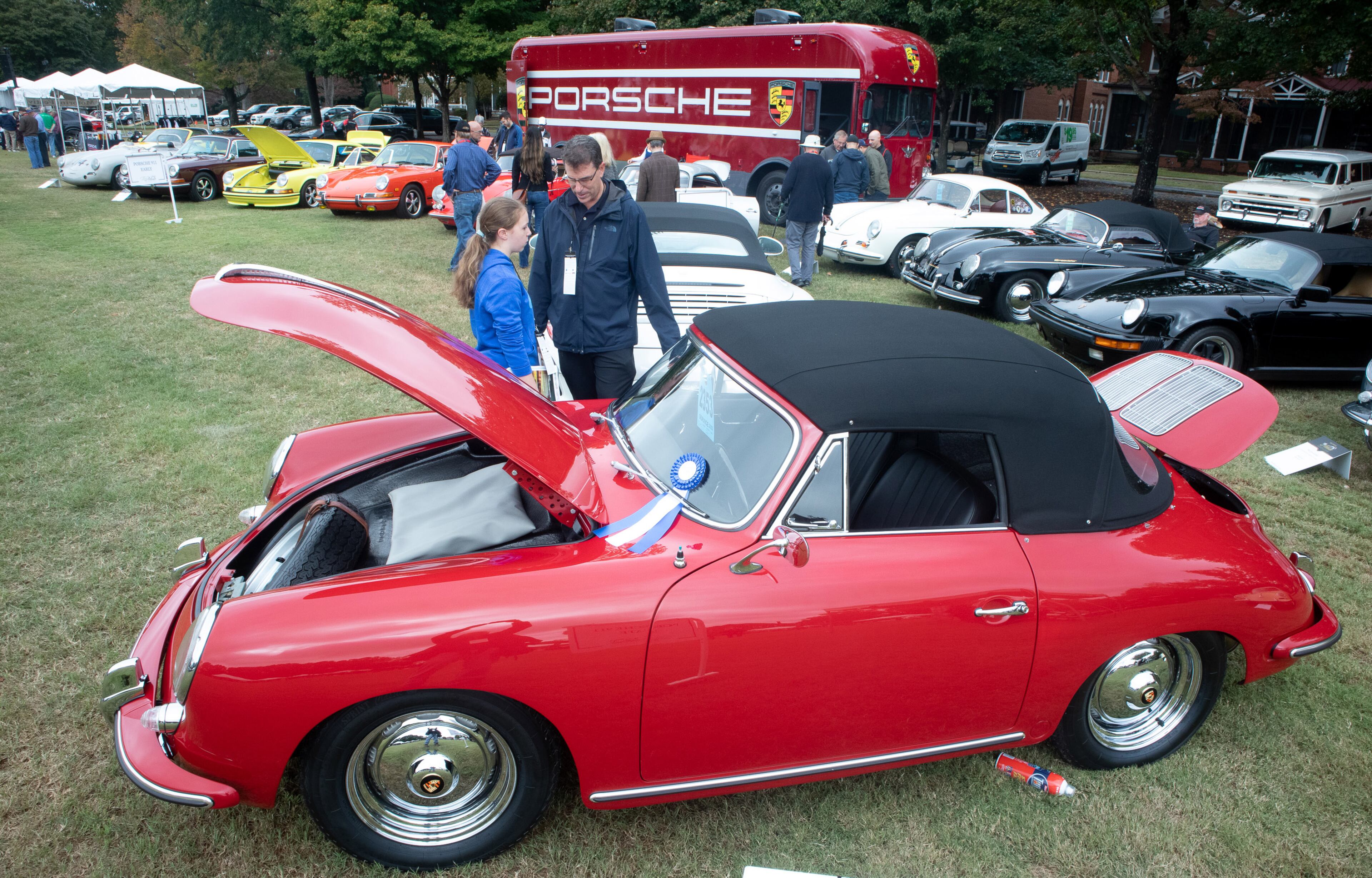 Tom Godfrey and his daughter Margaux look over a Porsche during the Atlanta Concours D'Elegance car show at Tyler Perry Studios in Atlanta on Sunday, October 20, 2019. STEVE SCHAEFER / SPECIAL TO THE AJC