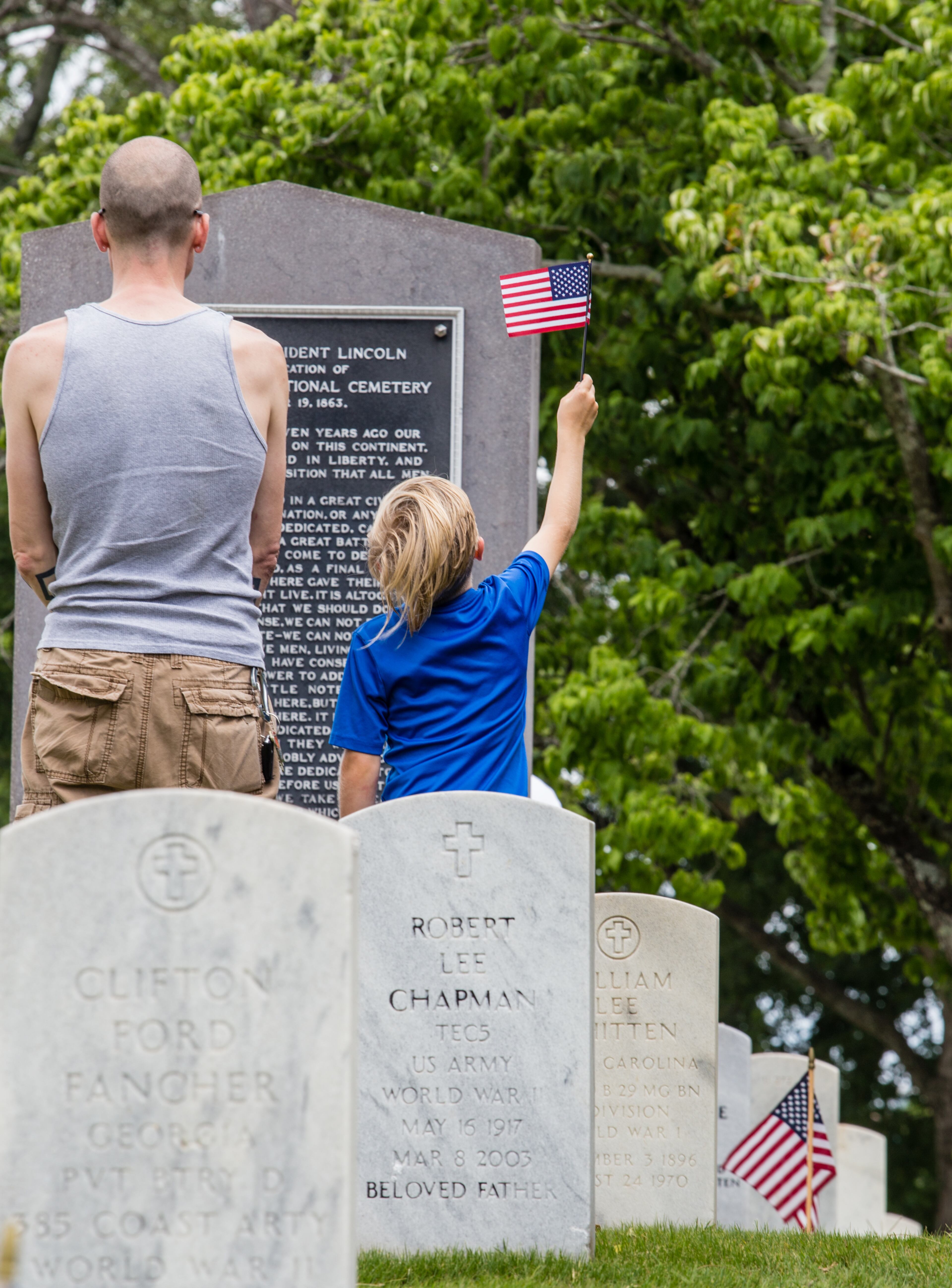 The Marietta National Cemetery did not hold official ceremonies this year, however, small groups gathered to watch the four Blackhawk helicopter flyover on Memorial Day, Monday, May 25, 2020. Veteran Ryan Durocher, left, brought his family, including 7-year-old Rylan Durocher, to see the Memorial Day flyover. (Jenni Girtman for The Atlanta Journal Constitution)