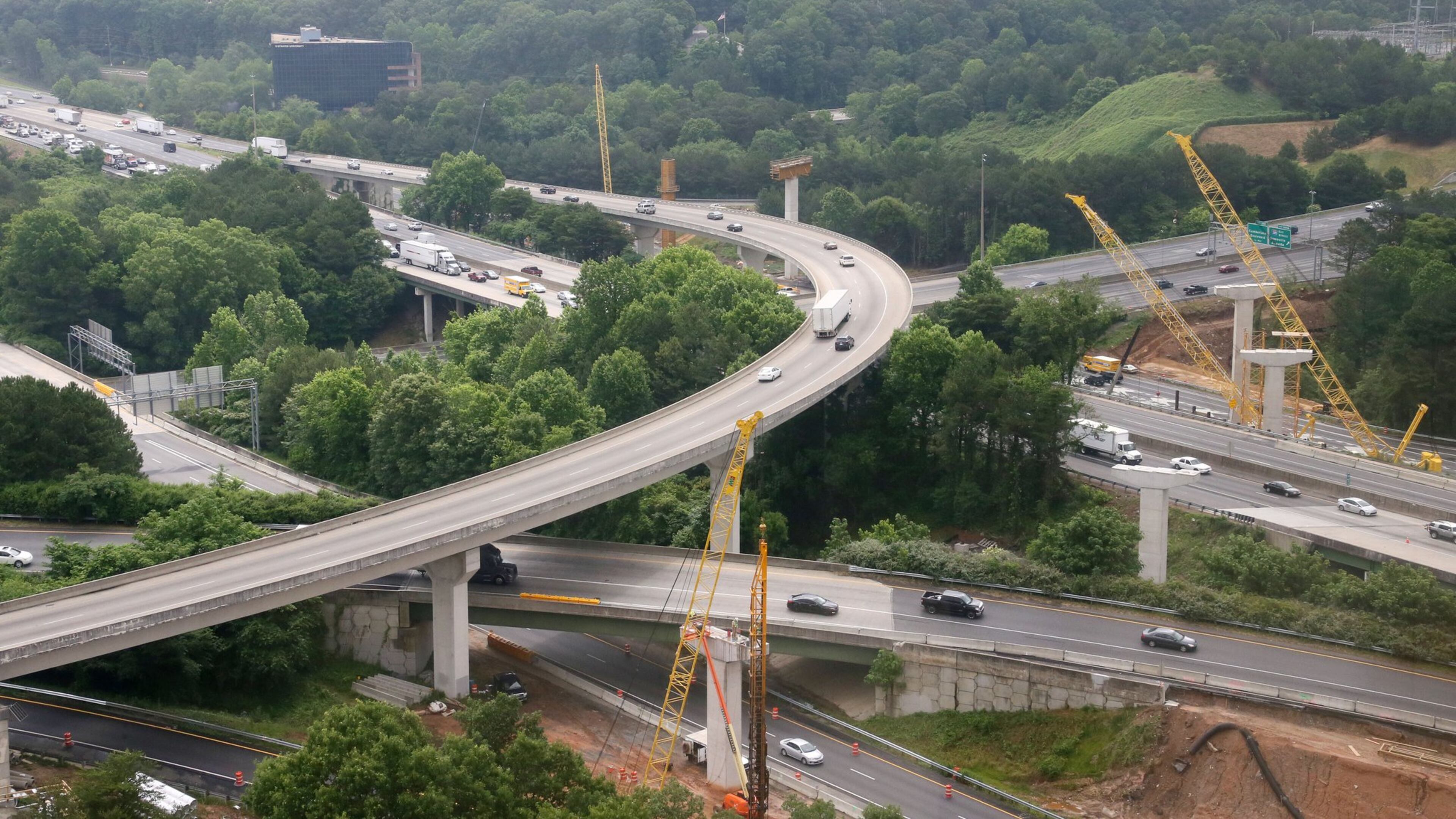 Express lane construction in late May at the I-285 and I-75 interchange. View showing the I-285 (running top left to bottom right) and I-75 interchange near the Sun Trust Park construction site. Visible is construction of an overpass . BOB ANDRES / BANDRES@AJC.COM