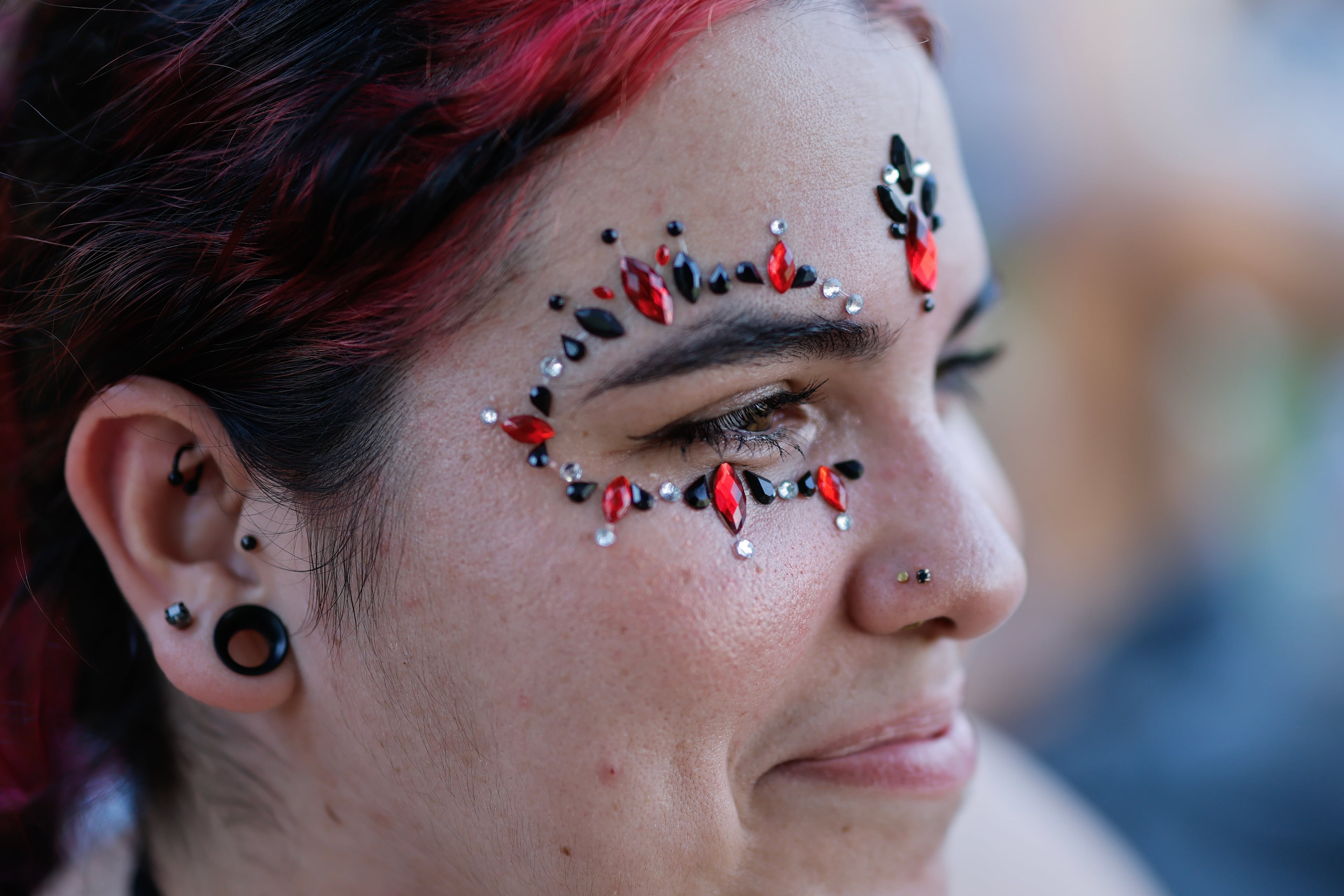 Daniela Tamayo wears face gems while attending the Shaky Knees music festival at Piedmont Park, Saturday, Sept. 19, 2026, in Atlanta. (Erik S. Lesser for the AJC)