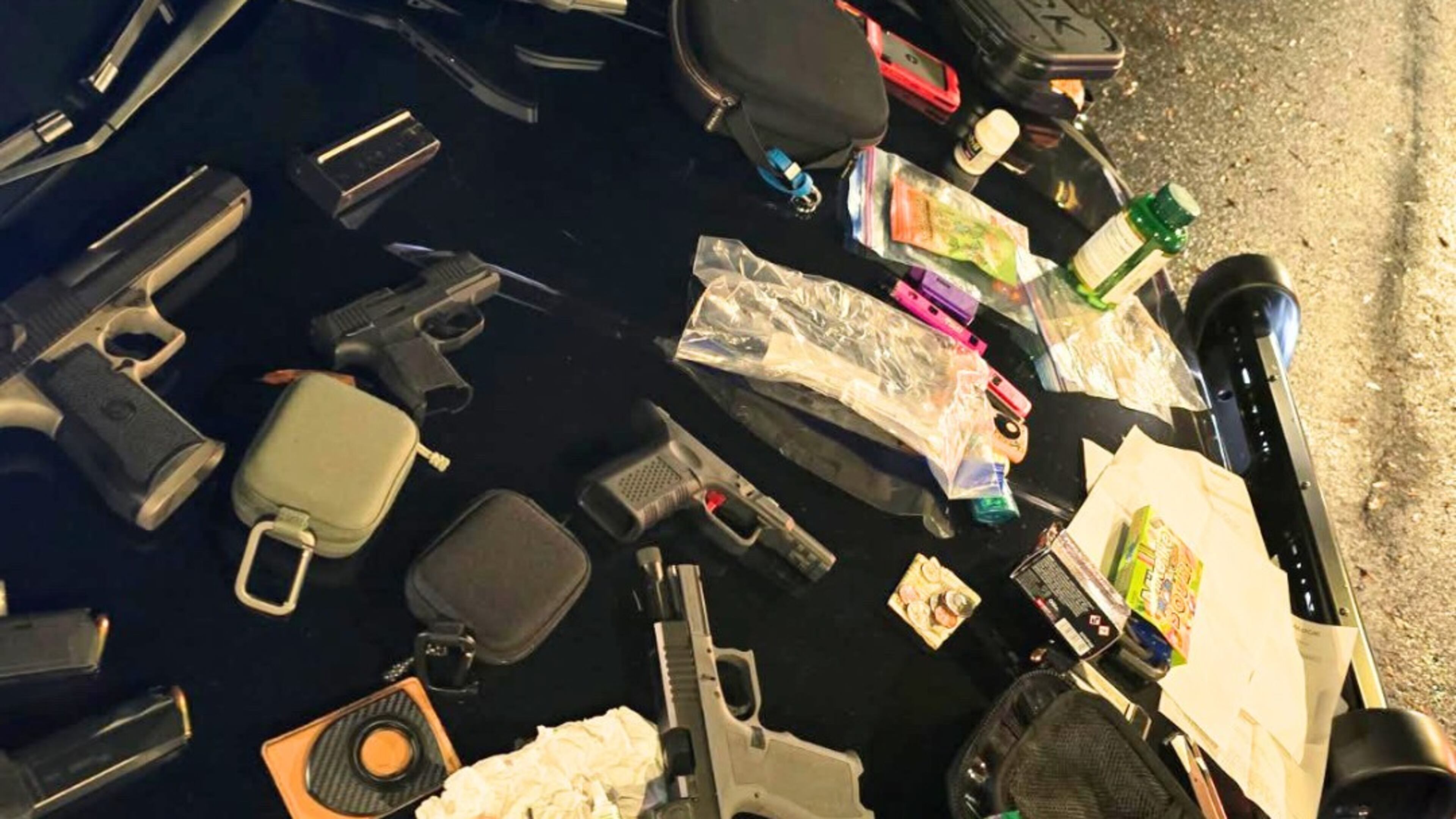 Police in Alpharetta found several handguns and a cache of illegal narcotics in a parked car on Thanksgiving morning. (Courtesy of the Alpharetta Police Department)