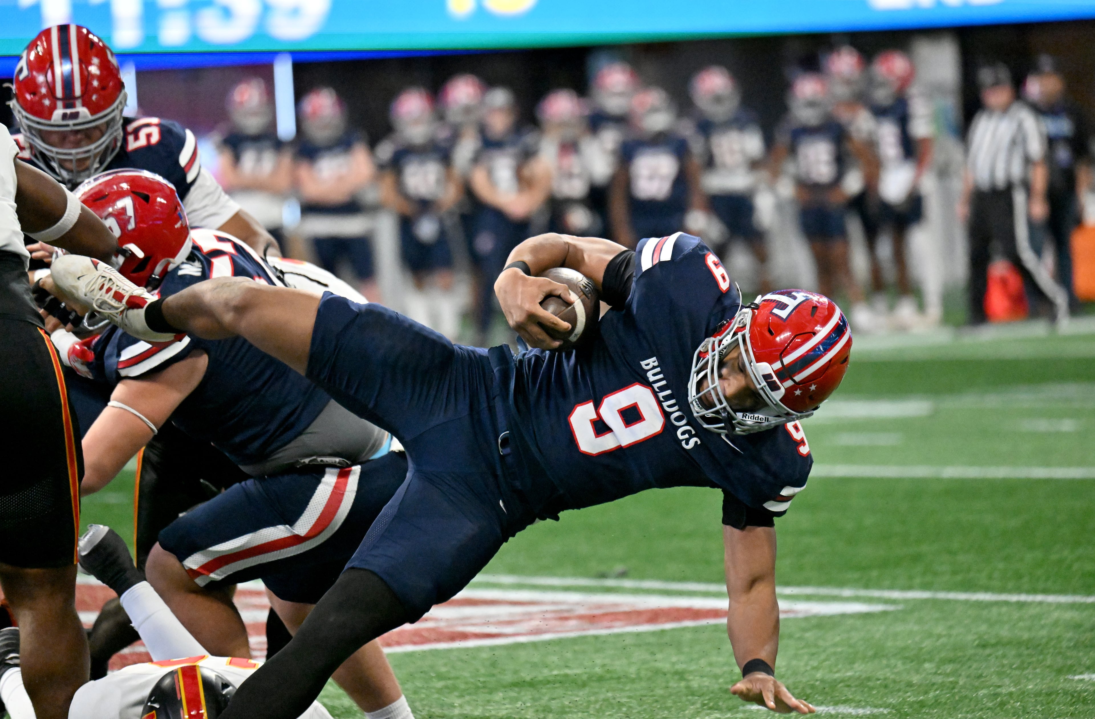 Toombs County's running back Justin Powell (9) leaps over for yardage during the first half in GHSA Class A-Division State Championship game at Mercedes-Benz Stadium, Tuesday, December 17, 2024, in Atlanta. (Hyosub Shin / AJC)