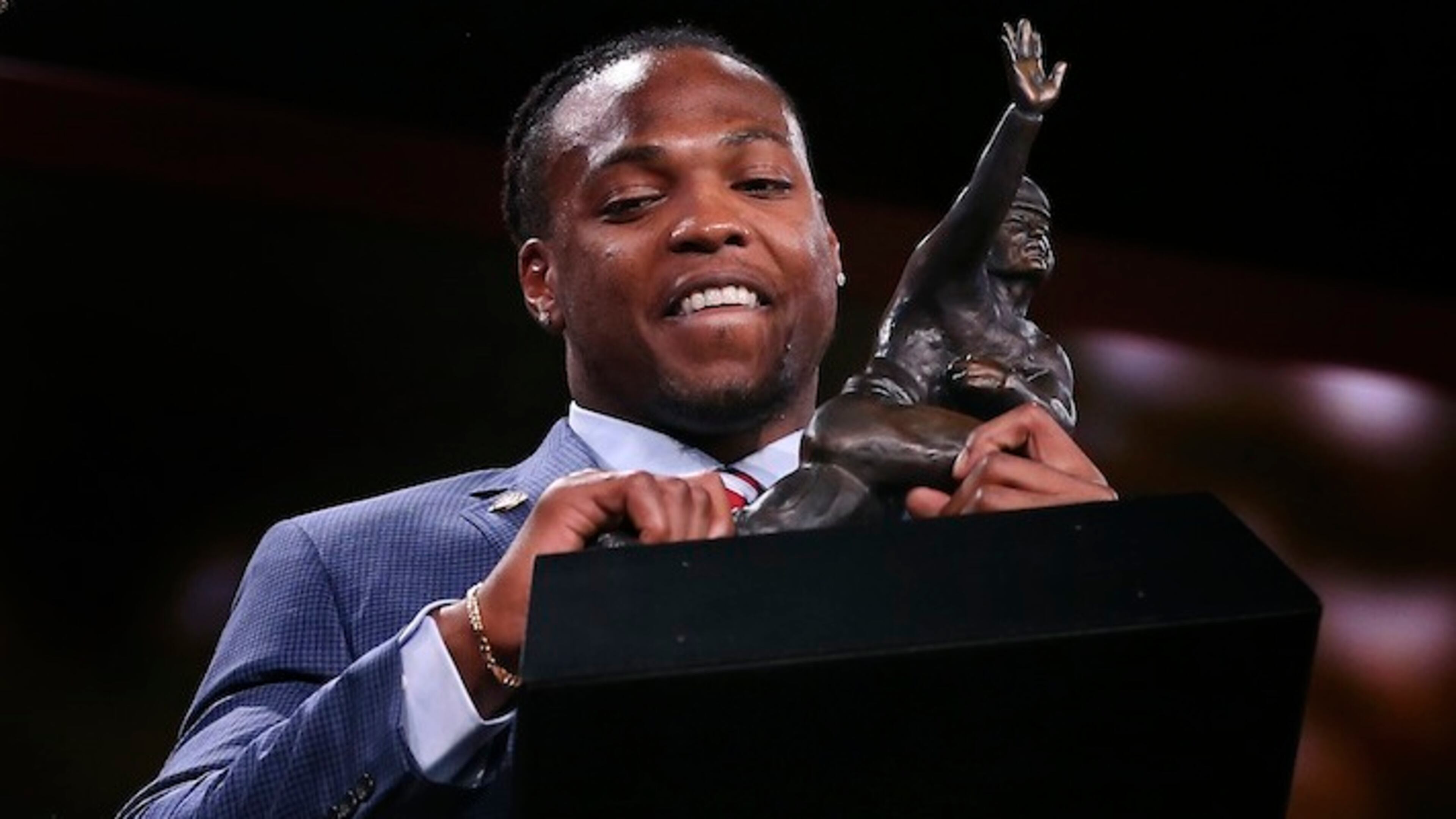 Alabama's Derrick Henry lifts up the Heisman Trophy after being announced as the winner, Saturday, Dec. 12, 2015, in New York. (AP Photo/Kelly Kline, Pool)