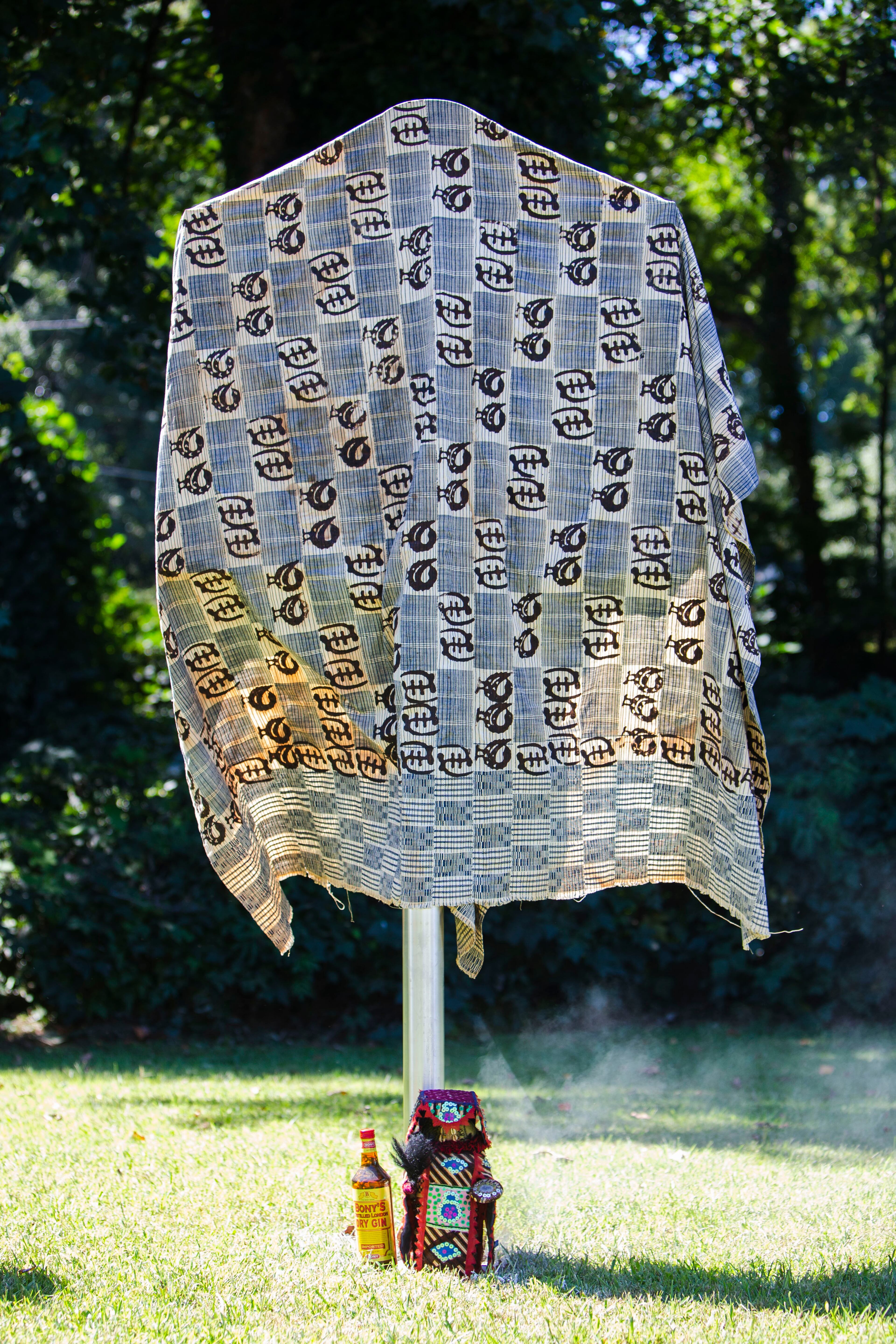 A historical marker for Zeb Long, a lynching victim from the 1906 Atlanta Race Massacre, waits to be unveiled on Saturday, September 24, 2022, at Sumner Park in East Point. The marker was draped in a cloth from Ghana with Adinkra symbols on it. CHRISTINA MATACOTTA FOR THE ATLANTA JOURNAL-CONSTITUTION