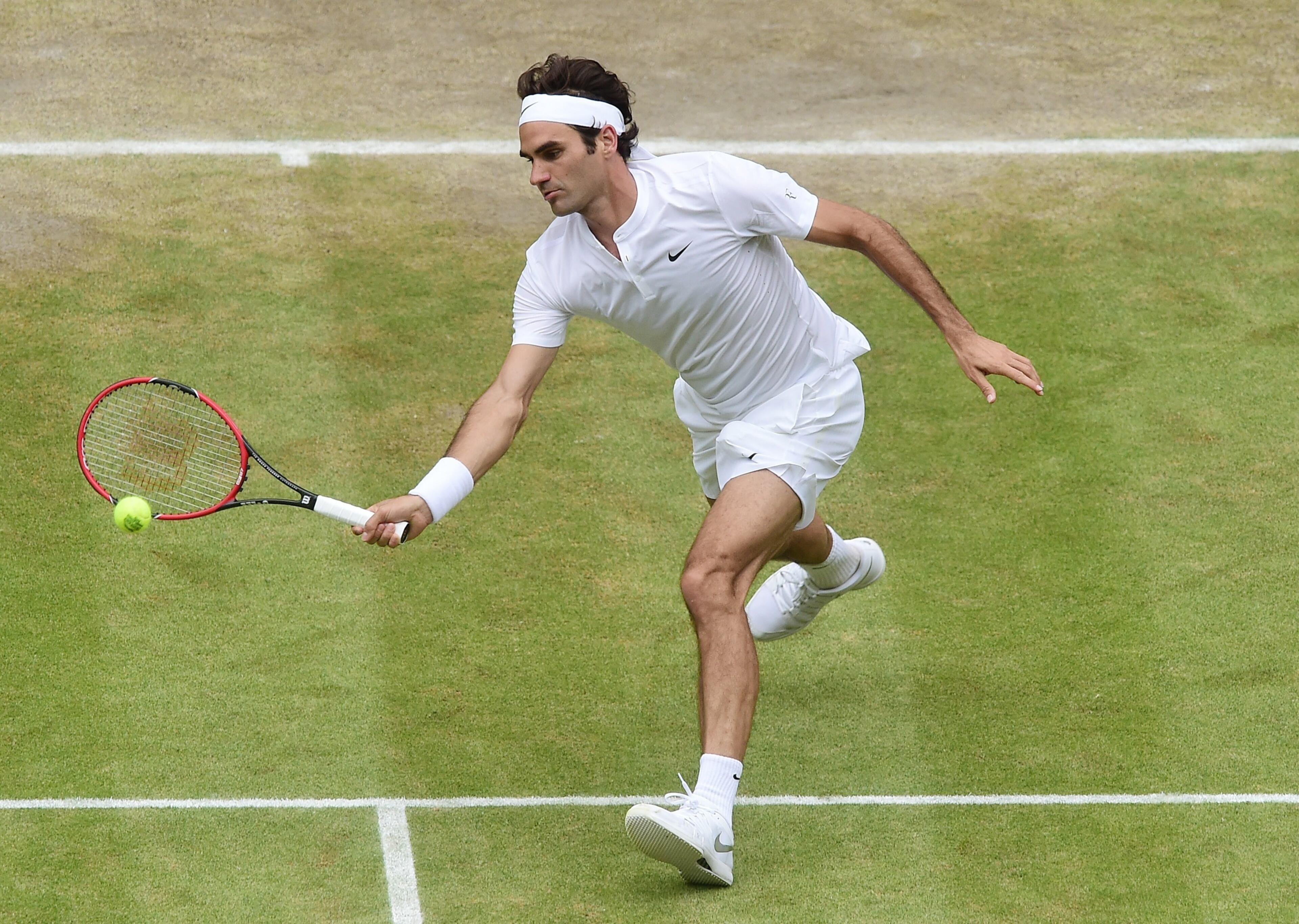 LONDON, ENGLAND - JULY 12: Roger Federer of Switzerland plays a forehand against Novak Djokovic of Serbia during the Final of the Gentlemen's Singles on day thirteen of the Wimbledon Lawn Tennis Championships at the All England Lawn Tennis and Croquet Club on July 12, 2015 in London, England. (Photo by Alex Broadway/Anadolu Agency/Getty Images)