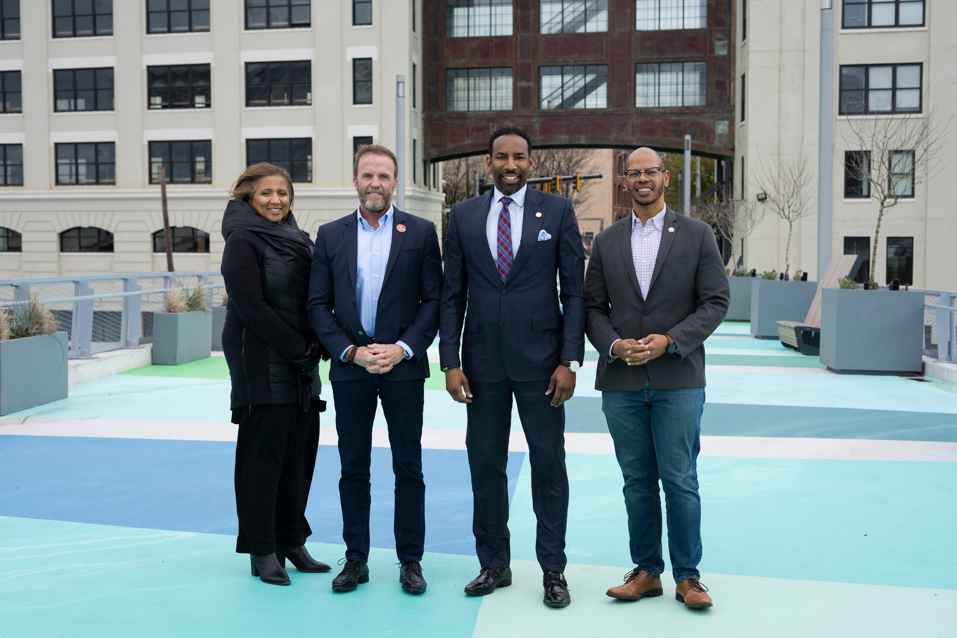 Atlanta Mayor Andre Dickens (center), joins Vice President, Business and Workforce Opportunity, Centennial Yards, Brigitte Broyard (from left), President of Centennial Yards, Brian McGowan, and Atlanta City Council member, Jason S. Dozier, to cross the brand new Nelson Street Bridge in Atlanta on Friday, Feb. 17, 2023. (Olivia Bowdoin for the Atlanta Journal Constitution).