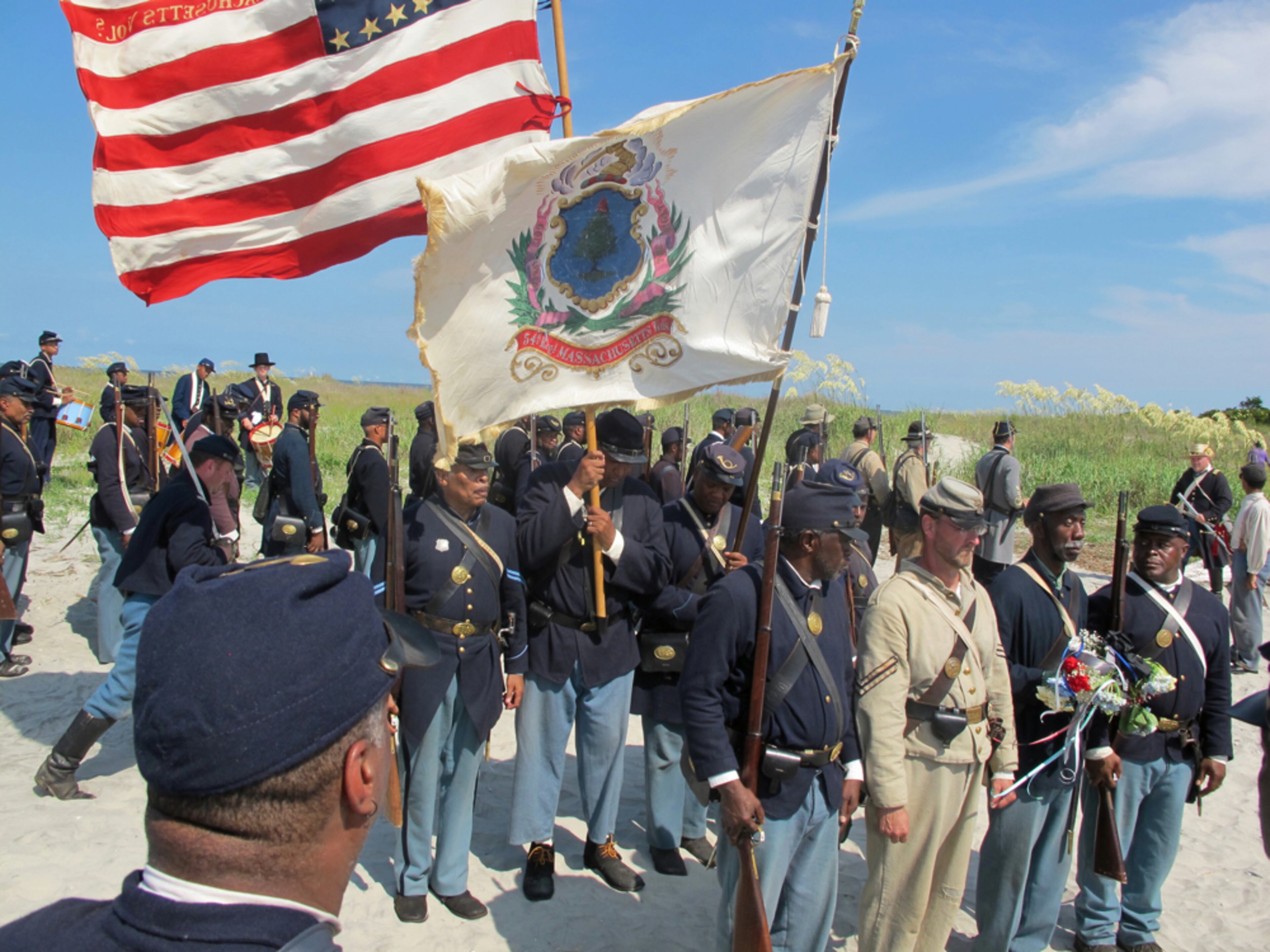 REMEMBERING HISTORY--Re-enactors prepare to lay a wreath on Morris Island near Charleston, S.C., on Thursday, July 18, 2013 during a observance of the 150th anniversary of the charge of the black 54th Massachusetts Volunteer Infantry in a fight commemorated in the film "Glory." (AP Photo/Bruce Smith)