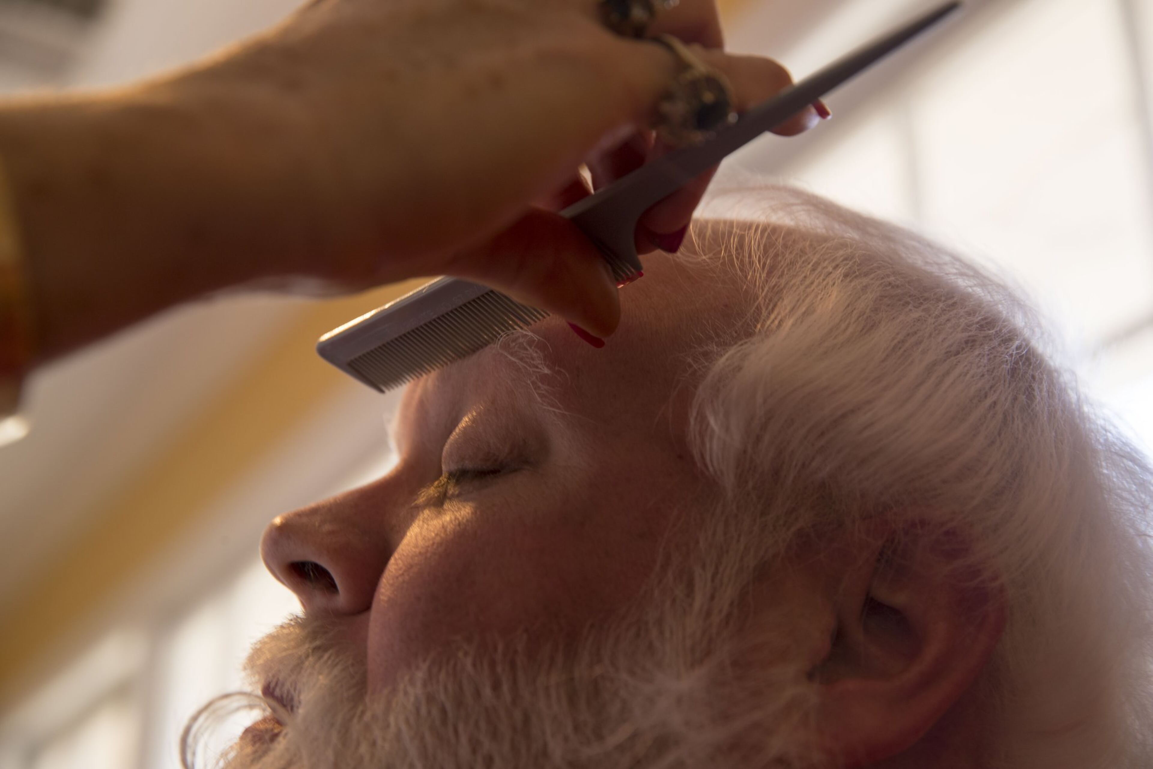 Hairstylist Sharon Franklin styles the eyebrows of “Santa” Damon Duncan at the end of his touch-up visit on Dec. 12, 2017. Damon, 42, says he begins his Santa Claus hair transformation process Oct. 1 of each year. ALYSSA POINTER / ALYSSA.POINTER@AJC.COM