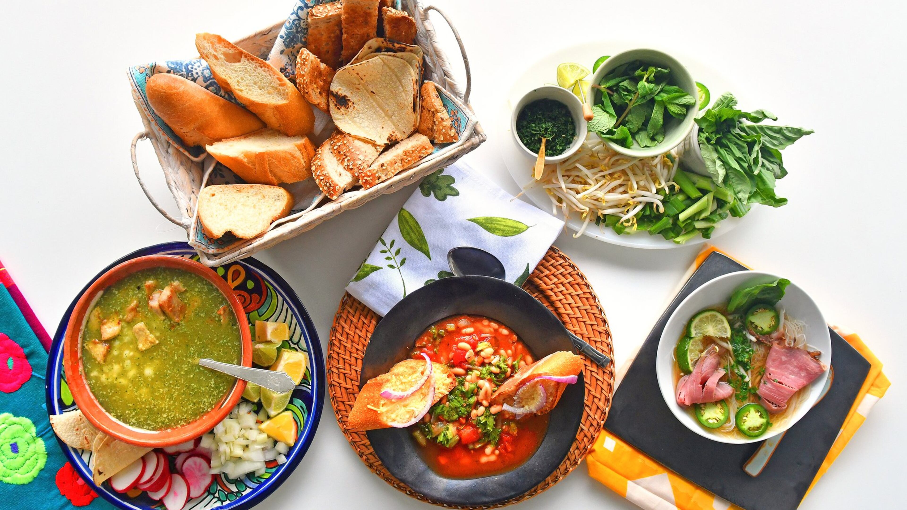 Whether it’s rainy or just chilly, you can take comfort in soups such as (bottom row, from left) Mexican Green Posole, Easy Italian Ribollita and Vietnamese Weeknight Beef Pho. STYLING BY LISA HANSON / CONTRIBUTED BY CHRIS HUNT PHOTOGRAPHY