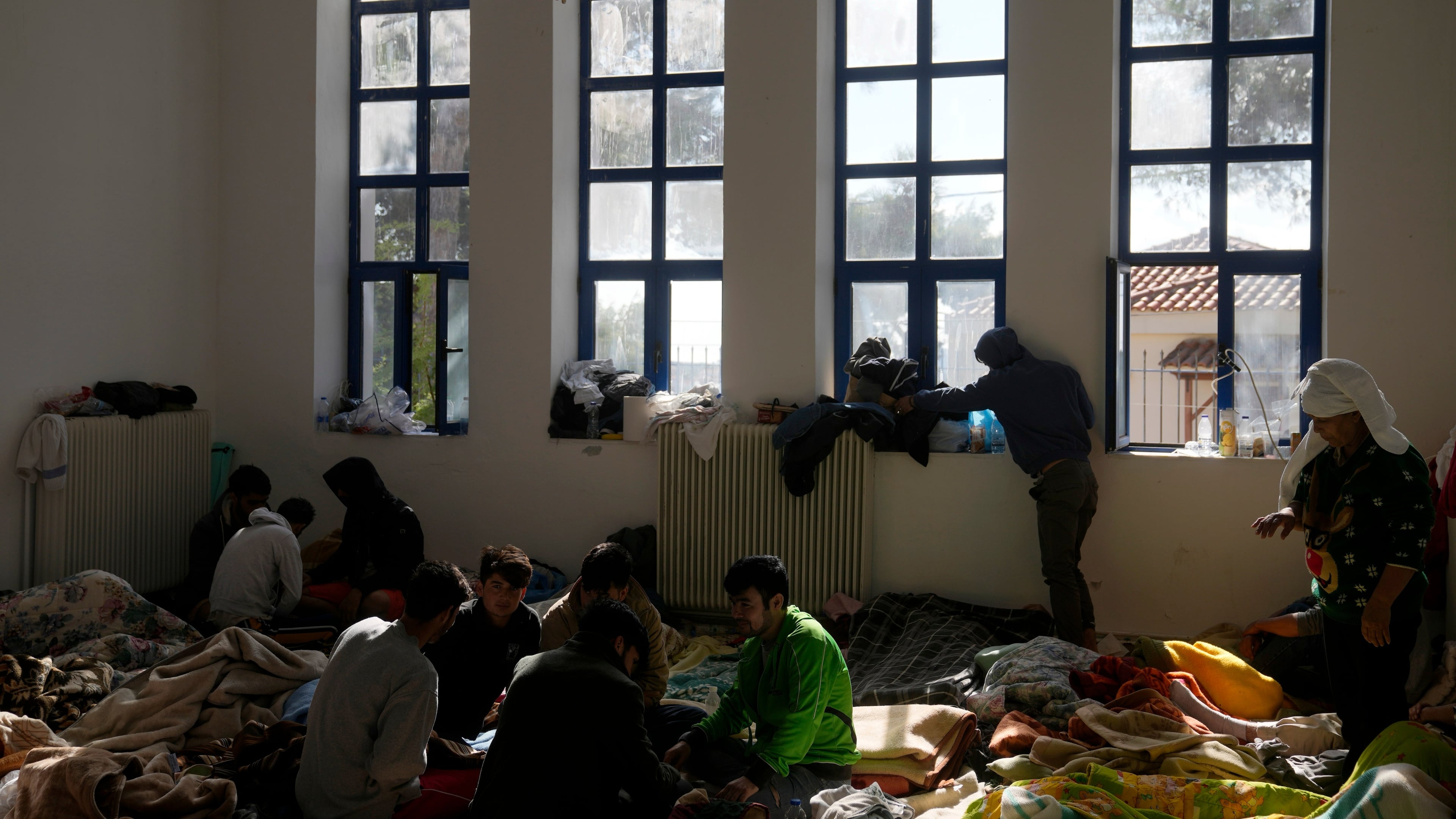 FILE - Migrants, most of them from Afghanistan, rest at an old school used as a temporary shelter on the island of Kythira, southern Greece, Oct. 7, 2022. (AP Photo/Thanassis Stavrakis, File)