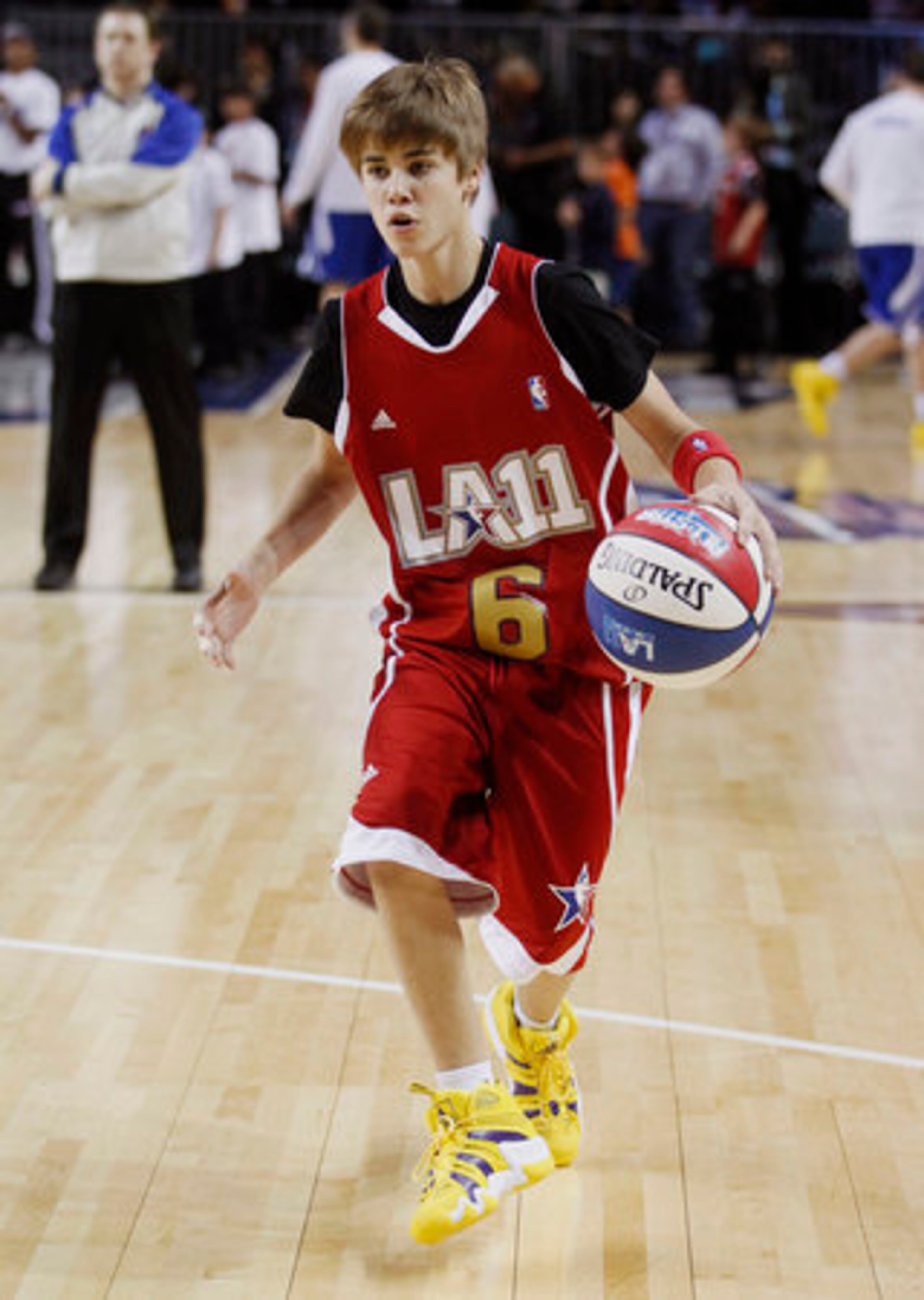 Singer Justin Bieber warms up before a BBVA All-Star celebrity basketball game at the NBA All Star Weekend in Los Angeles, Friday, Feb. 18, 2011. (AP Photo/Jae C. Hong)