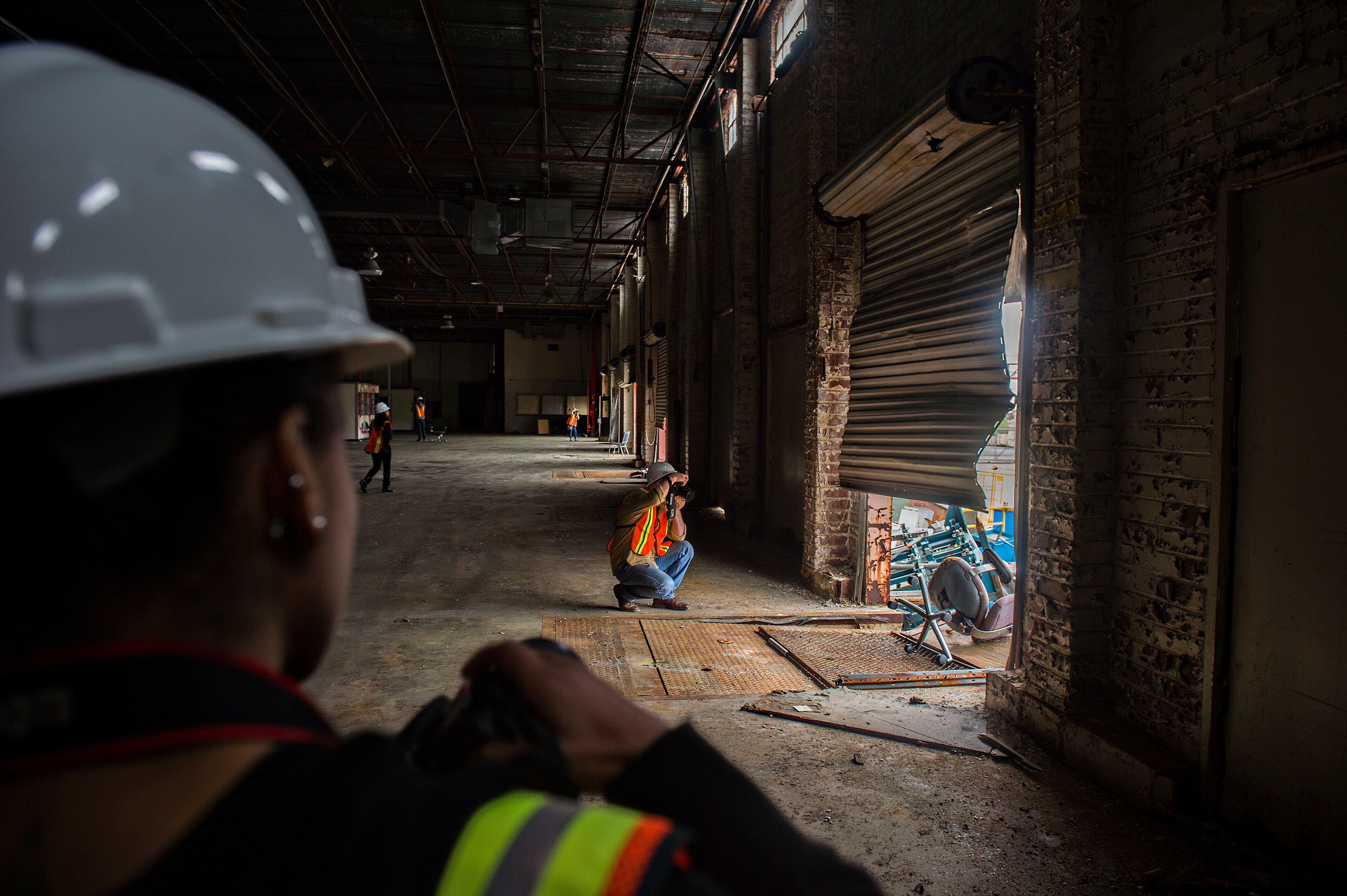 April 12, 2015 Doraville - Stan Mayhew (center) and Porsche Rittenhouse take photographs in one of the buildings inside the General Motors assembly plant in Doraville during a #weloveatl photowalk on Sunday, April 12, 2015. 120 photographers were given special access to the plant that is being demolished and re-imagined into a multi-use space. JONATHAN PHILLIPS / SPECIAL
