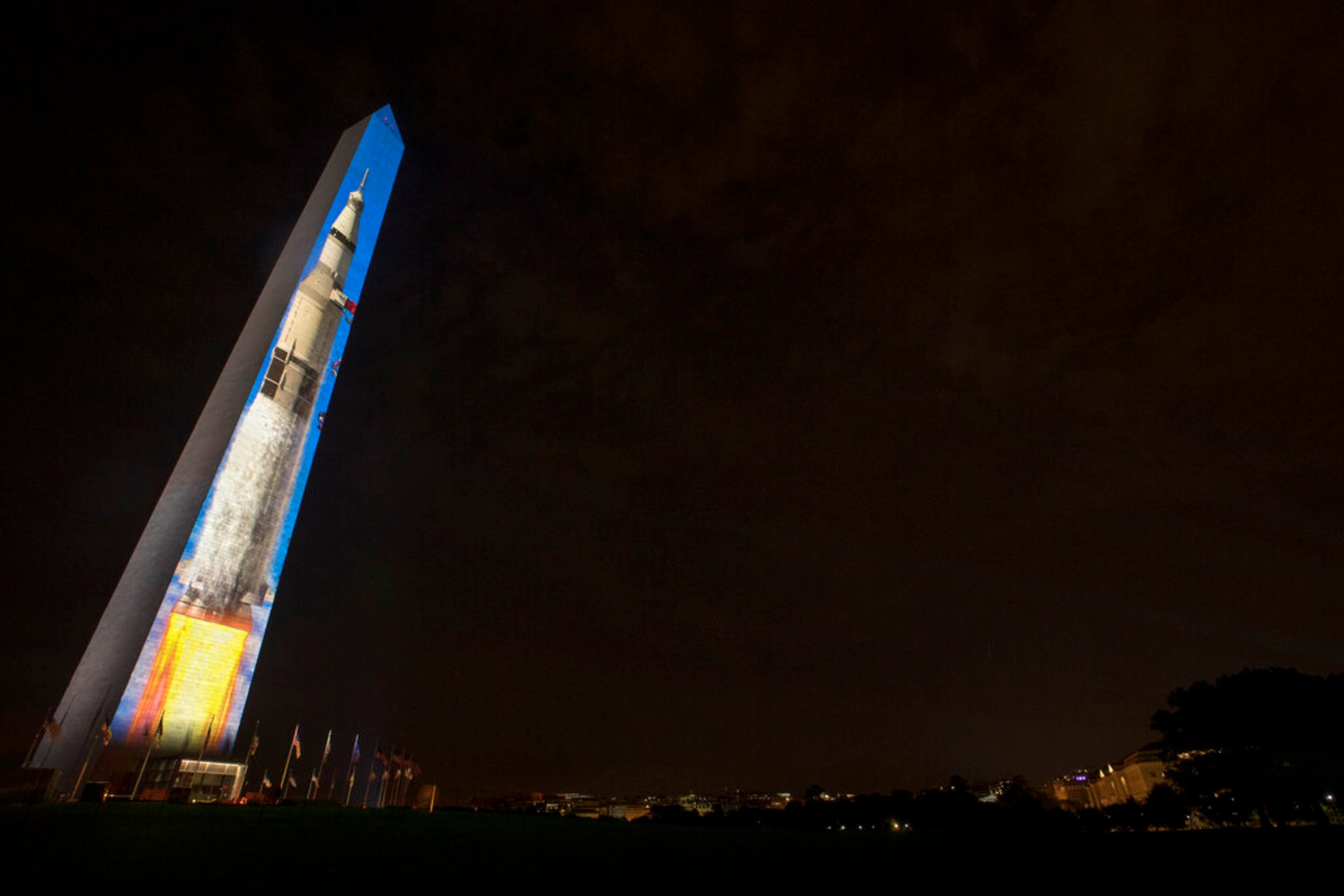 The image of a 363-foot Saturn V rocket is projected on the east face of the Washington Monument in Washington, Wednesday, July 17, 2019, in celebration of the 50th anniversary of the Apollo 11 moon landing. (AP Photo/Andrew Harnik)